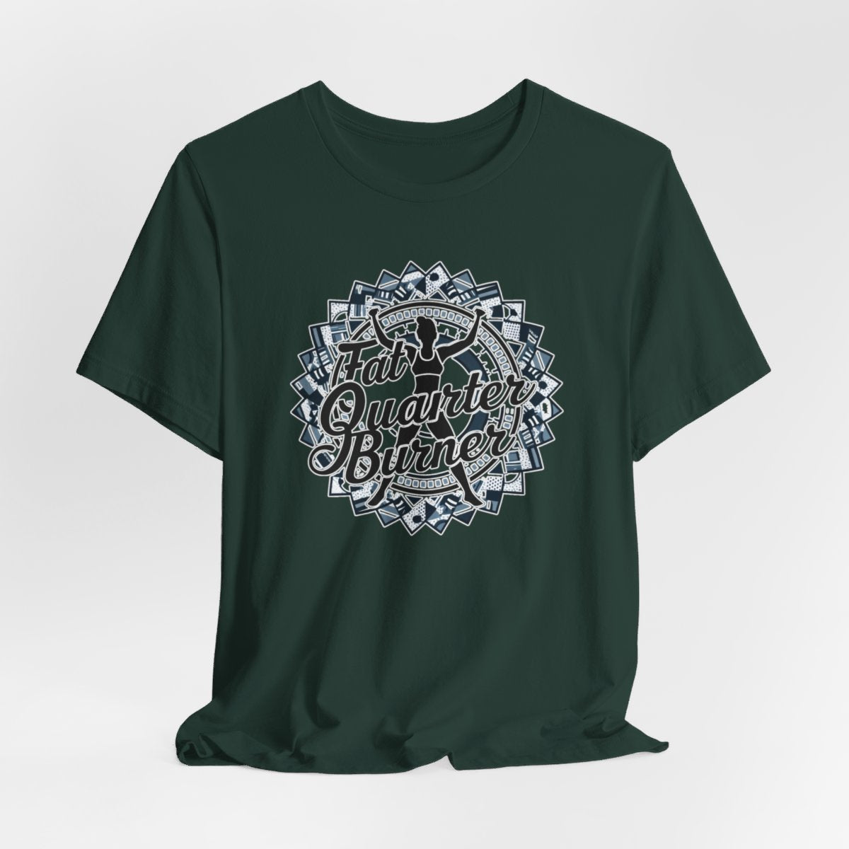 A Forest T-Shirt featuring a patchwork border surrounding silhouette of woman lifting weights. Text reads "Fat Quarter Burner" in bold script.