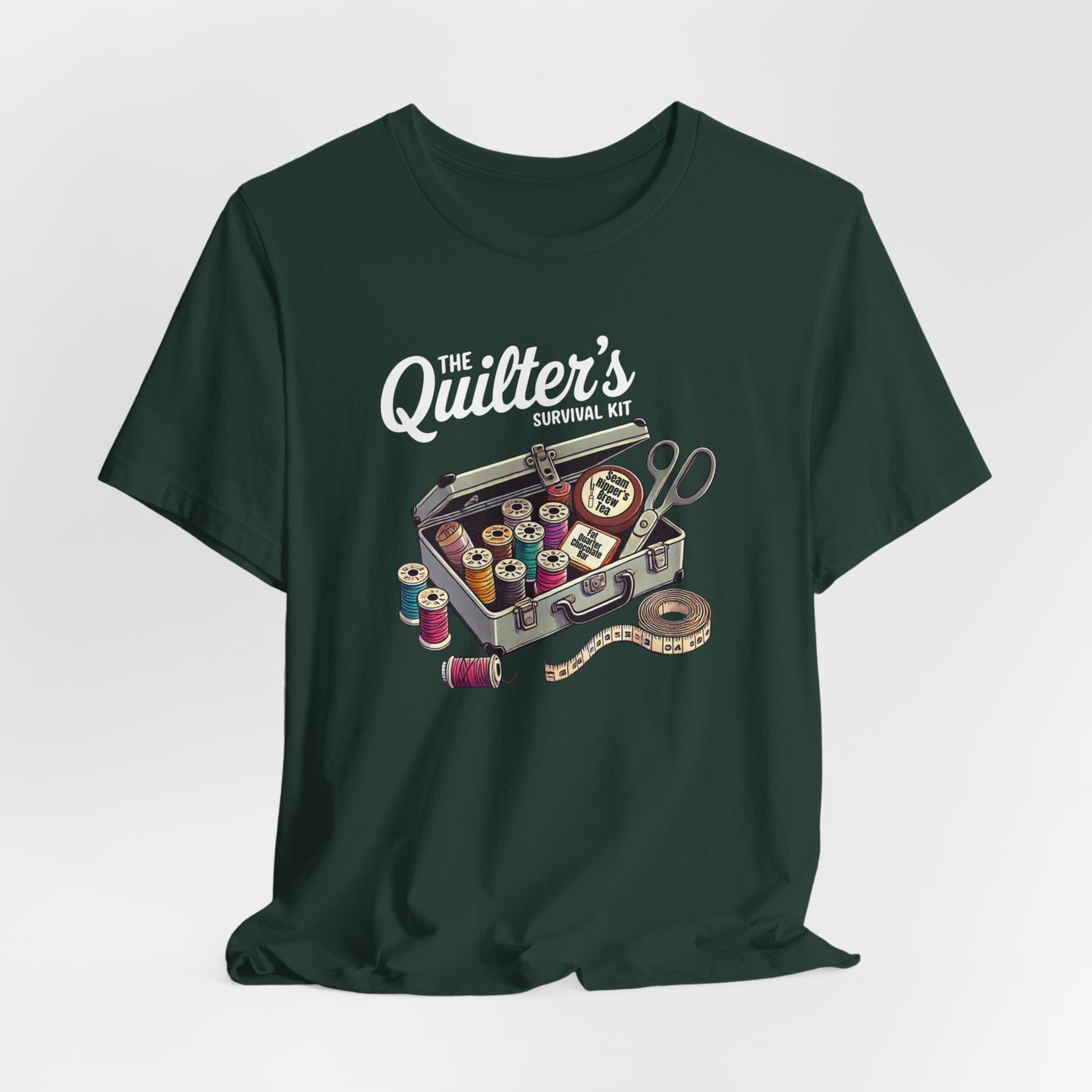 A Forest t-shirt featuring a whimsical illustration of a quilter’s survival kit with colorful thread spools, scissors, and a tape measure, perfect for sewing and quilting enthusiasts.
