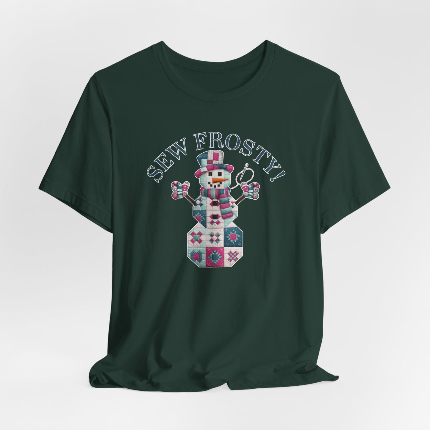 A Forest christmas quilting t-shirt featuring cute snowman made of patchwork quilt blocks with the phrase "Sew Frosty" above, holding a needle to highlight the quilting theme.