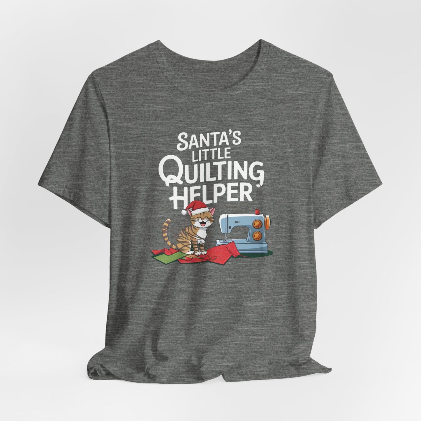 A Deep Heather christmas quilting t-shirt featuring a playful cat wearing a Santa hat is tangled in thread next to a sewing machine, with the phrase "Santa's Little Quilting Helper" above, combining quilting and holiday humor.