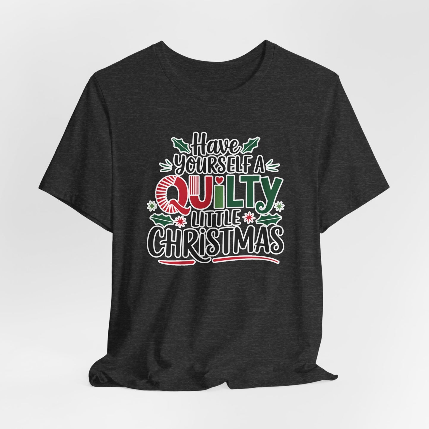 A Dark Grey Heather fun holiday-themed t-shirt featuring the phrase "Have Yourself a Quilty Little Christmas" with quilting-inspired elements and holiday decorations such as holly and stars.