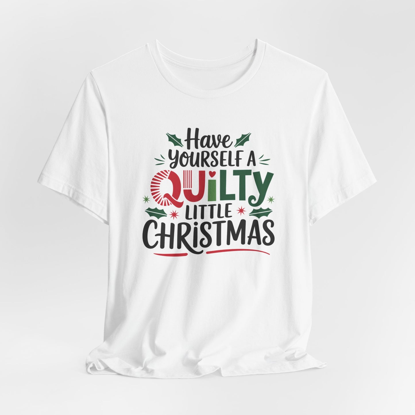 A White fun holiday-themed t-shirt featuring the phrase "Have Yourself a Quilty Little Christmas" with quilting-inspired elements and holiday decorations such as holly and stars.