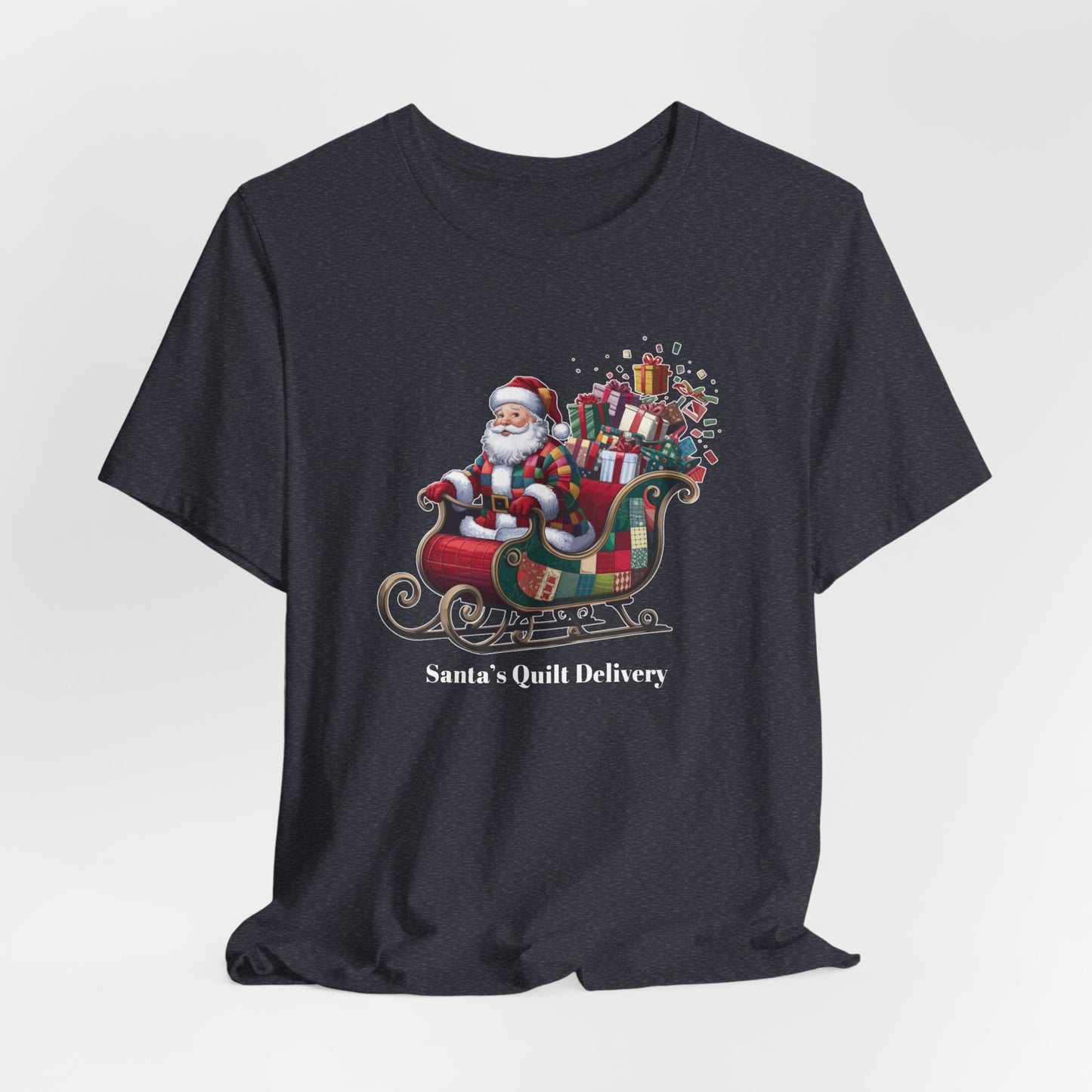A Heather Navy christmas quilting t-shirt featuring Santa Claus wearing a patchwork quilt coat, sitting in a sleigh filled with gifts and quilts, with the phrase "Santa's Quilt Delivery" below, combining holiday cheer and quilting fun.
