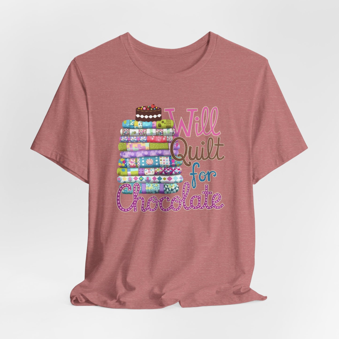 A Heather Mauve t-shirt featuring a whimsical design of a colorful stack of quilts topped with a chocolate cake and the phrase 'Will Quilt for Chocolate,' perfect for quilters who love sweets.
