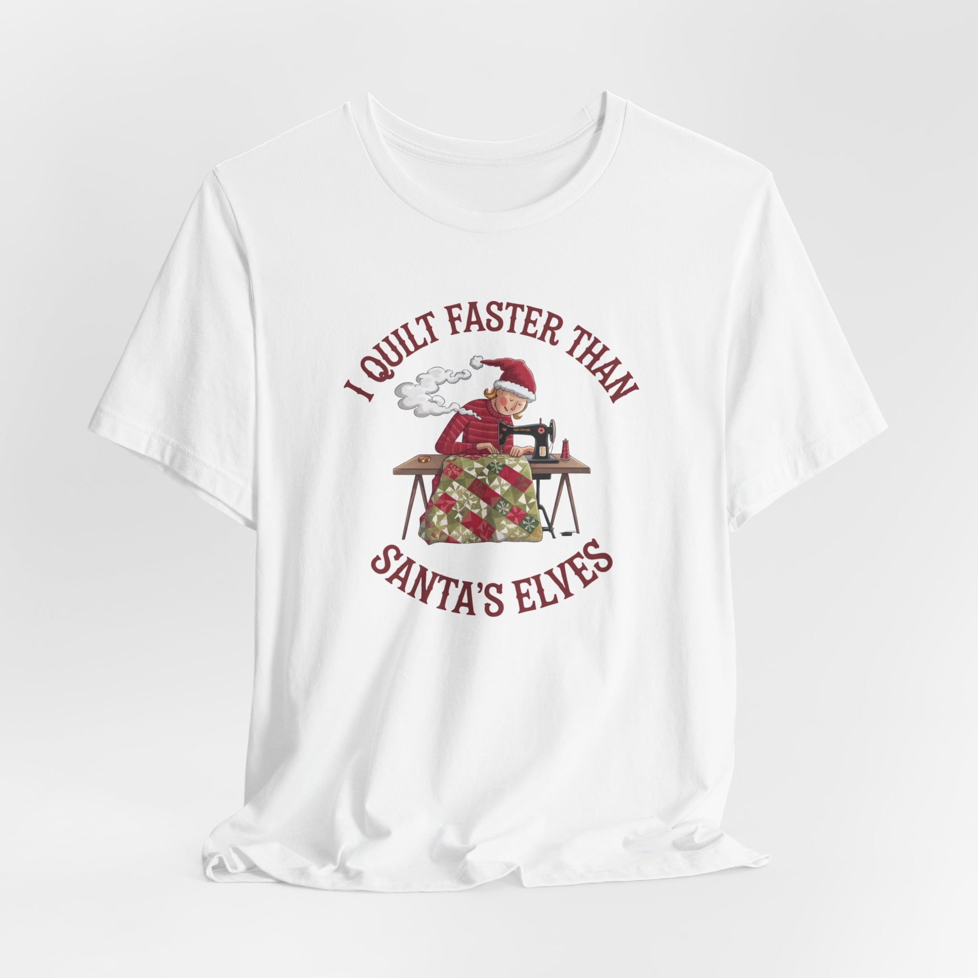 A White christmas quilting t-shirt featuring  a quilter working at a sewing machine, quilting a festive holiday quilt, with the phrase "I Quilt Faster Than Santa's Elves" above the image, highlighting the speed and skill of the quilter.