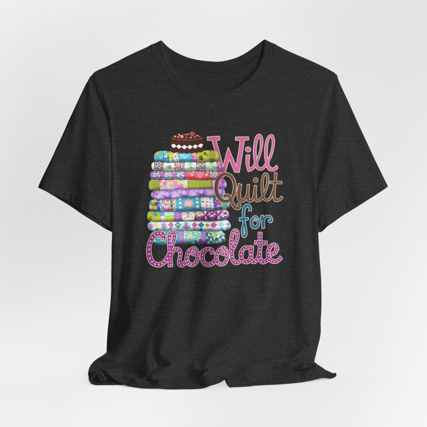 A Dark Grey Heather t-shirt featuring a whimsical design of a colorful stack of quilts topped with a chocolate cake and the phrase 'Will Quilt for Chocolate,' perfect for quilters who love sweets.