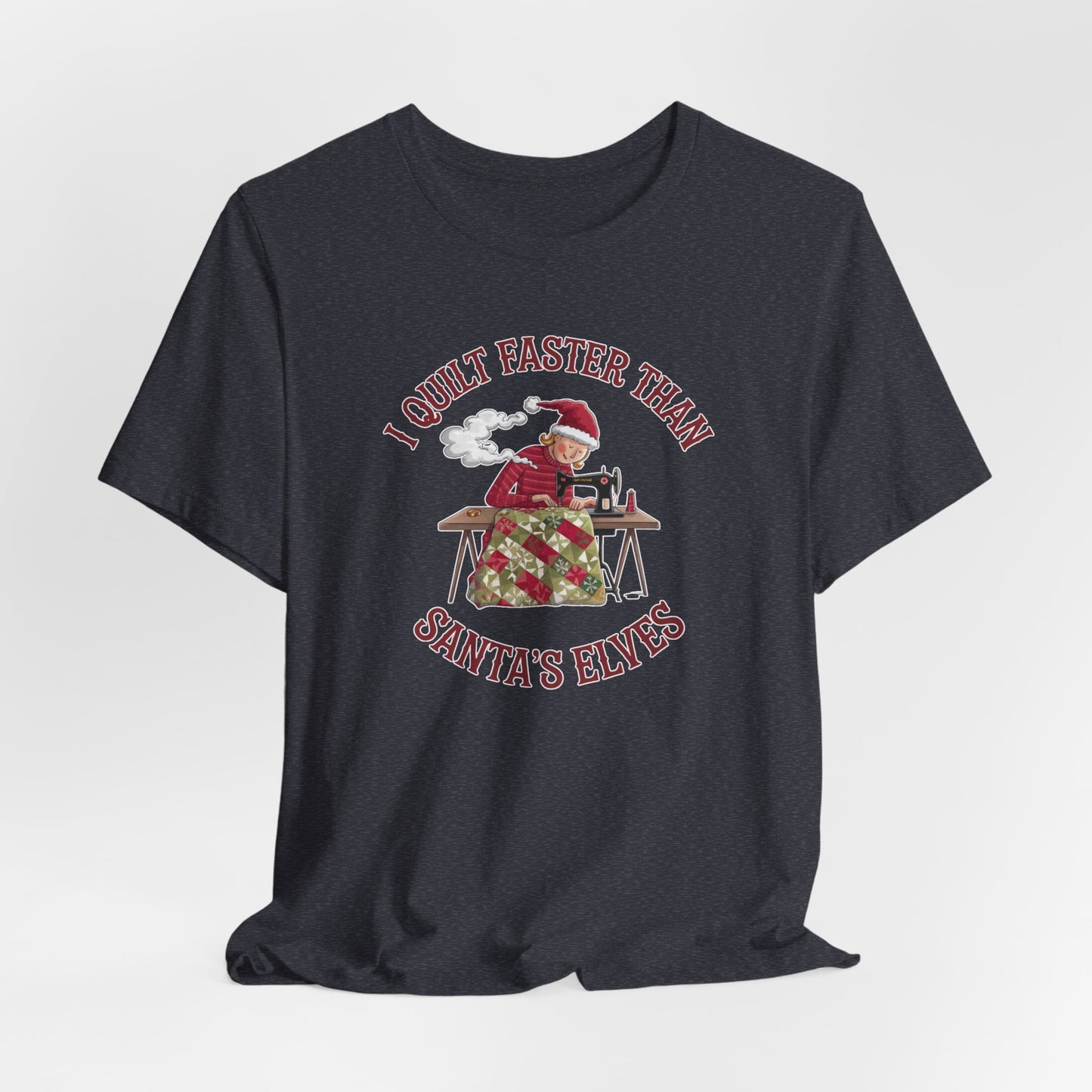 A Heather Navy christmas quilting t-shirt featuring a quilter working at a sewing machine, quilting a festive holiday quilt, with the phrase "I Quilt Faster Than Santa's Elves" above the image, highlighting the speed and skill of the quilter.