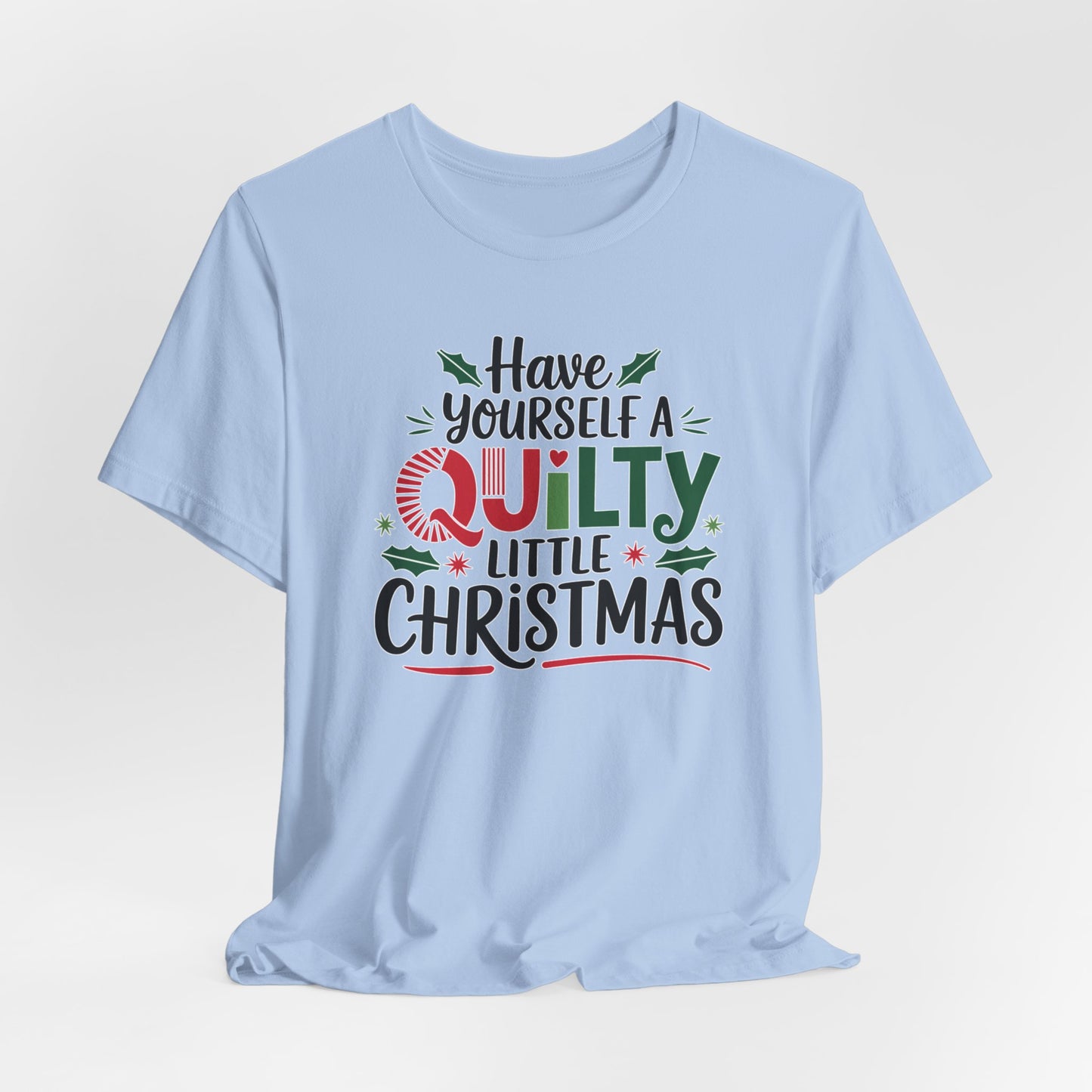 A Baby Blue fun holiday-themed t-shirt featuring the phrase "Have Yourself a Quilty Little Christmas" with quilting-inspired elements and holiday decorations such as holly and stars.