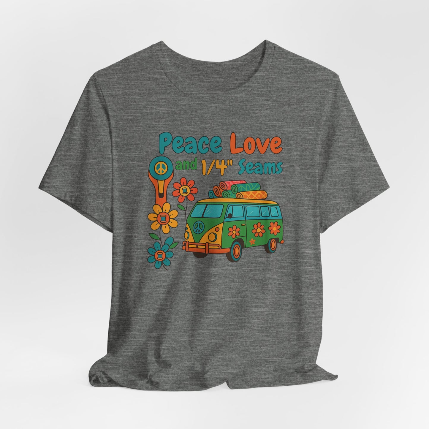 A A Deep Heather t-shirt with colorful retro design showing a peace sign rotary cutter, patchwork van, and text “Peace Love and 1/4" Seams.” Surrounded by flowers made of thread spools. Fun vintage-style quilting shirt.