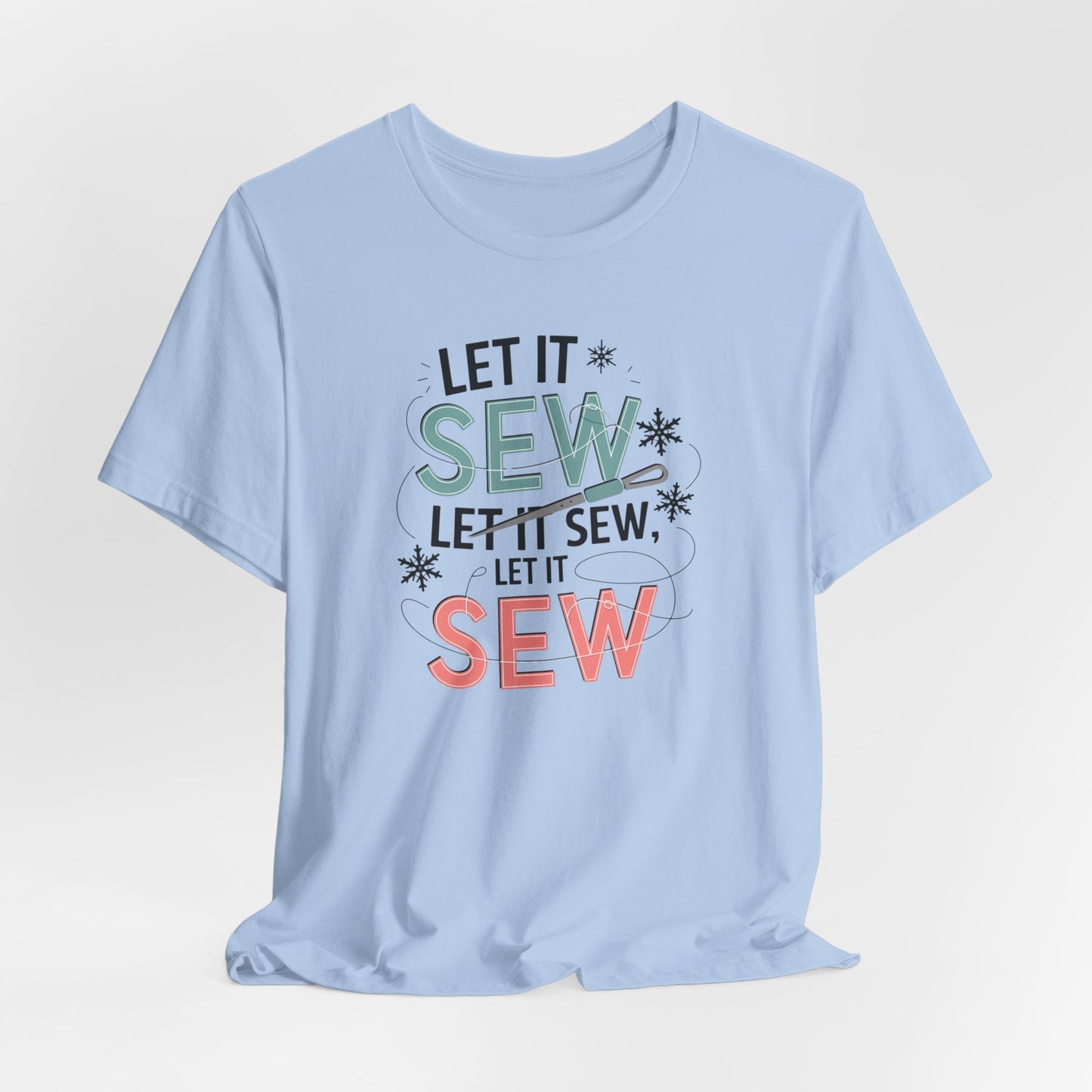 A Baby Blue christmas quilting t-shirt featuring the phrase "Let it Sew, Let it Sew, Let it Sew" featuring a needle and thread weaving through the letters, accented by snowflakes to bring out the holiday theme.