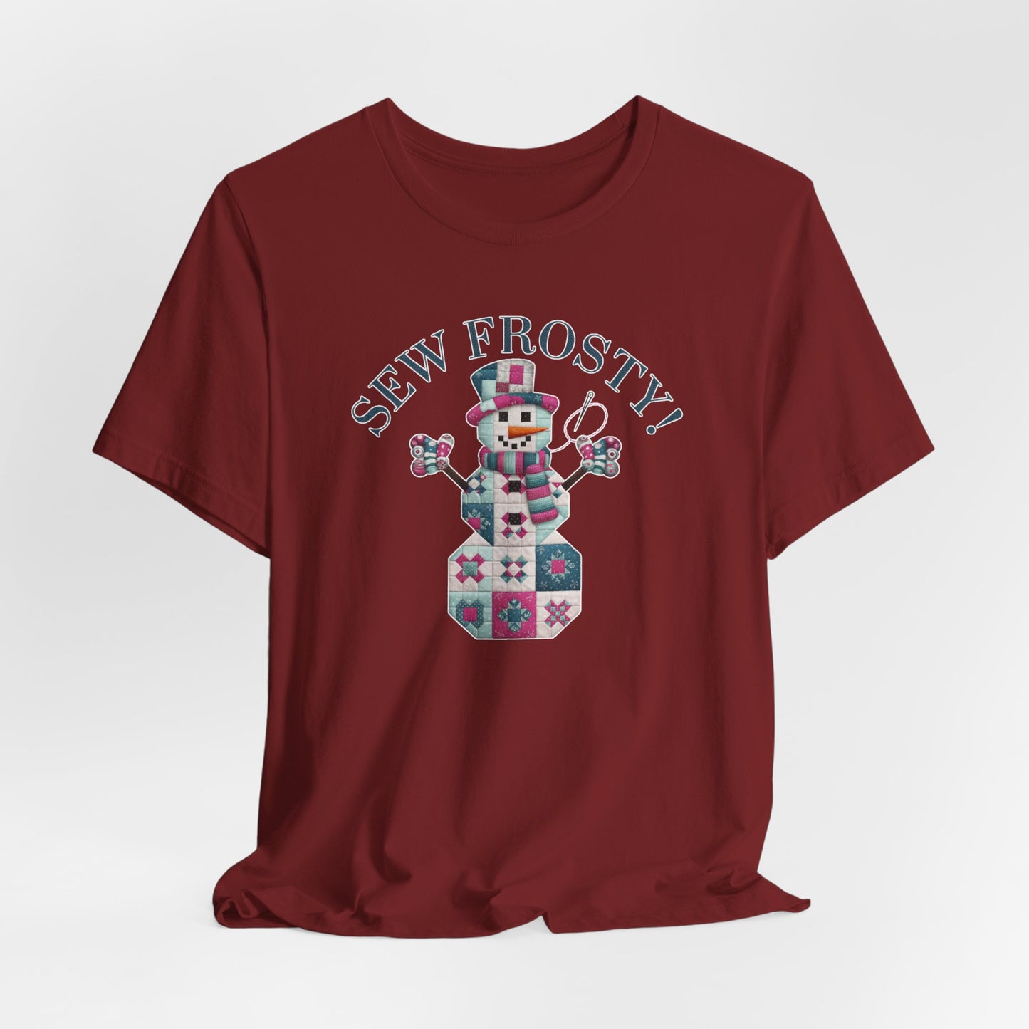 A Cardinal christmas quilting t-shirt featuring cute snowman made of patchwork quilt blocks with the phrase "Sew Frosty" above, holding a needle to highlight the quilting theme.