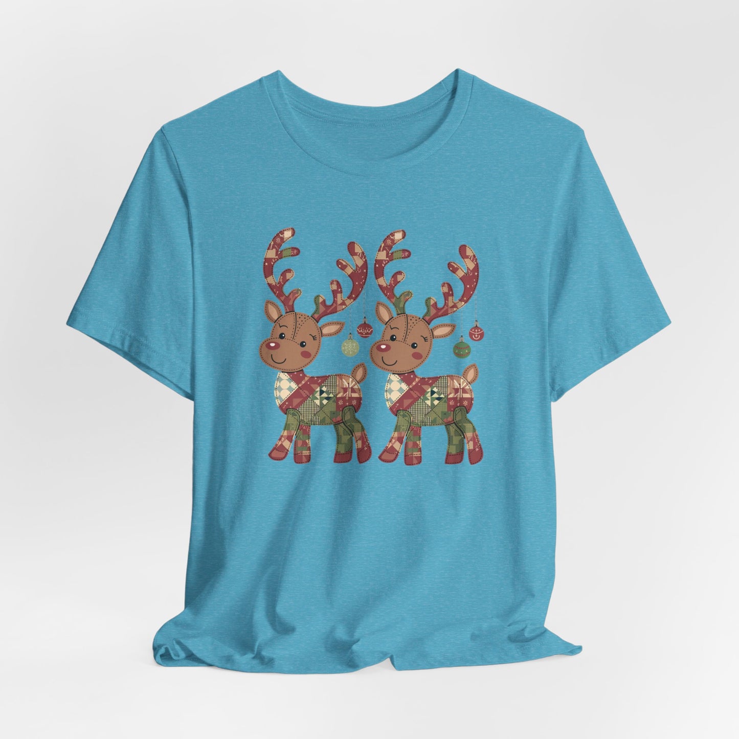 A Heather Aqua christmas quilting t-shirt featuring two adorable reindeer featuring patchwork quilt designs on their bodies, with ornaments hanging from their antlers, blending Christmas cheer with quilting creativity.