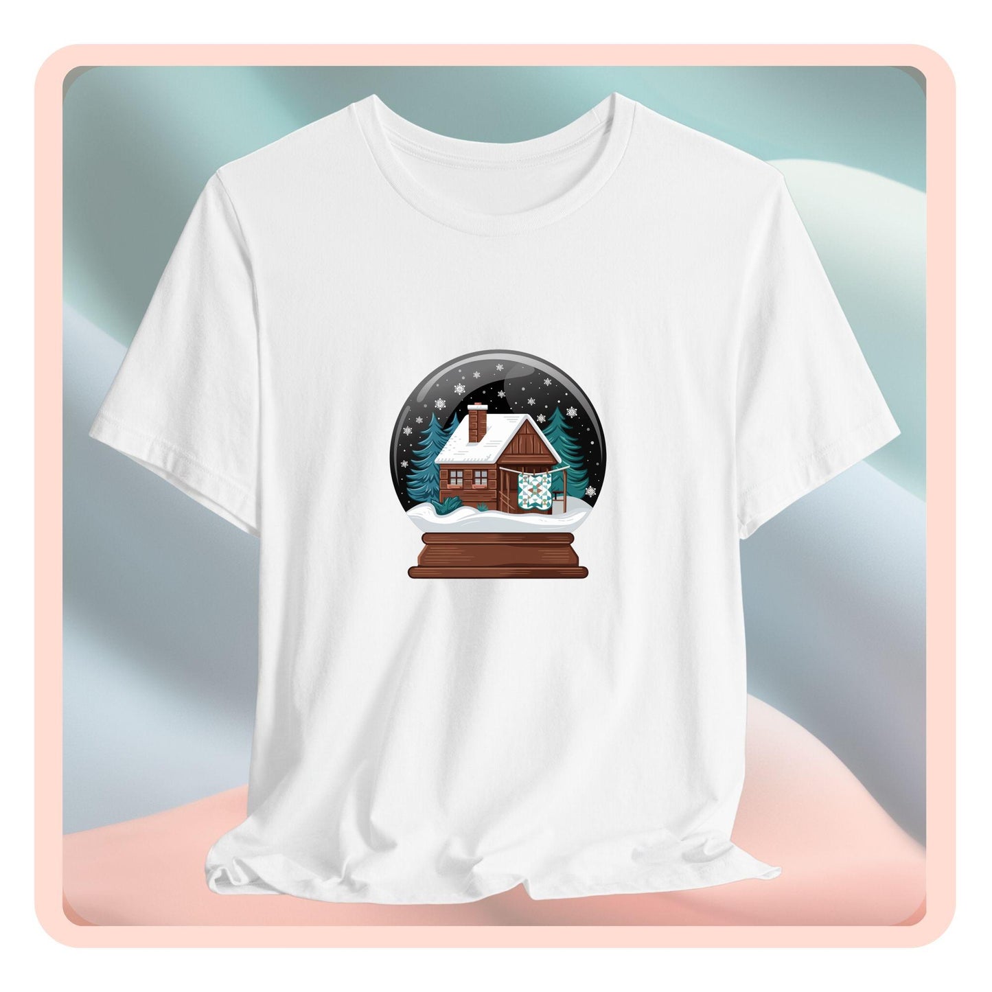 A christmas quilting t-shirt featuring a cozy log cabin covered in snow, with a quilt hanging outside, set inside a snow globe with swirling snowflakes, blending quilting and holiday warmth.