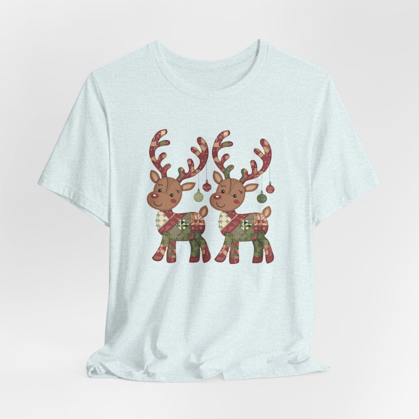 A Heather Ice Blue christmas quilting t-shirt featuring two adorable reindeer featuring patchwork quilt designs on their bodies, with ornaments hanging from their antlers, blending Christmas cheer with quilting creativity.