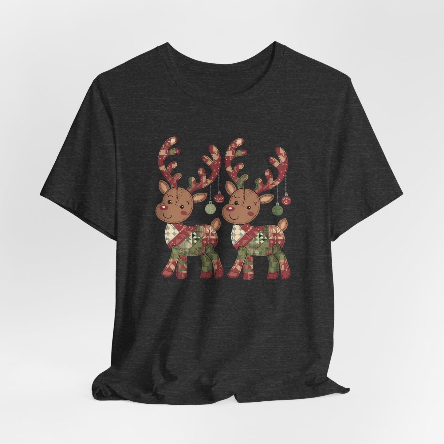 A Dark Grey Heather christmas quilting t-shirt featuring two adorable reindeer featuring patchwork quilt designs on their bodies, with ornaments hanging from their antlers, blending Christmas cheer with quilting creativity.