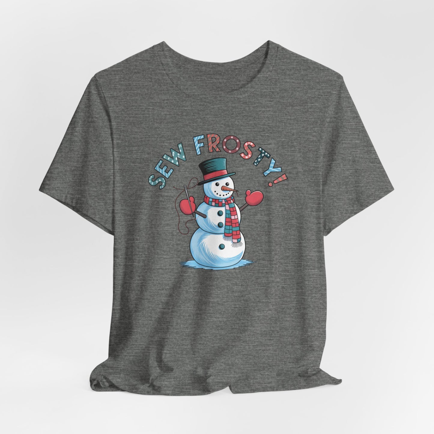 A Deep Heather christmas quilting t-shirt featuring cheerful snowman design holding a sewing needle, with the phrase "Sew Frosty" in playful, winter-themed lettering. The snowman is wearing a scarf and mittens, ready for holiday sewing fun.