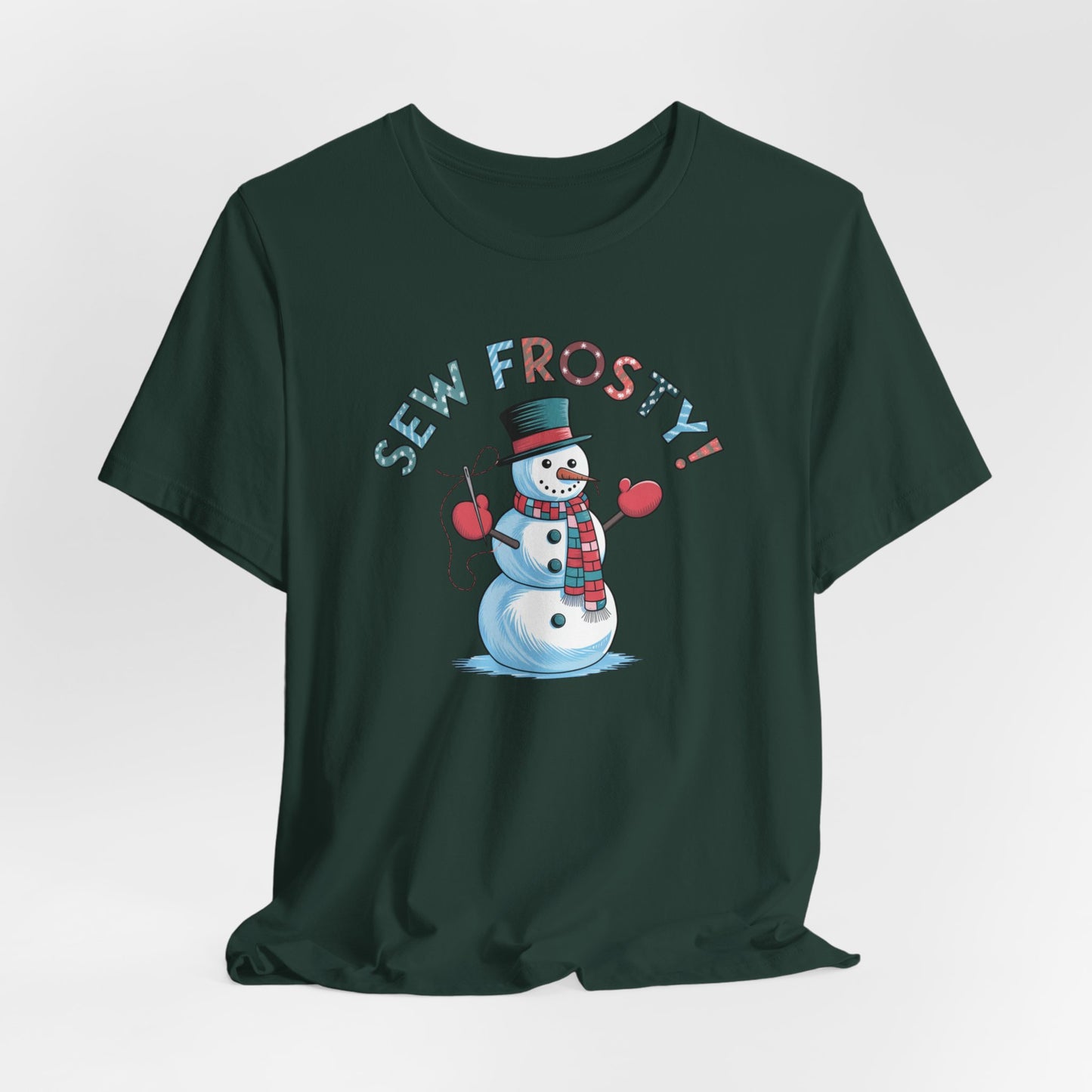 A Forest christmas quilting t-shirt featuring cheerful snowman design holding a sewing needle, with the phrase "Sew Frosty" in playful, winter-themed lettering. The snowman is wearing a scarf and mittens, ready for holiday sewing fun.