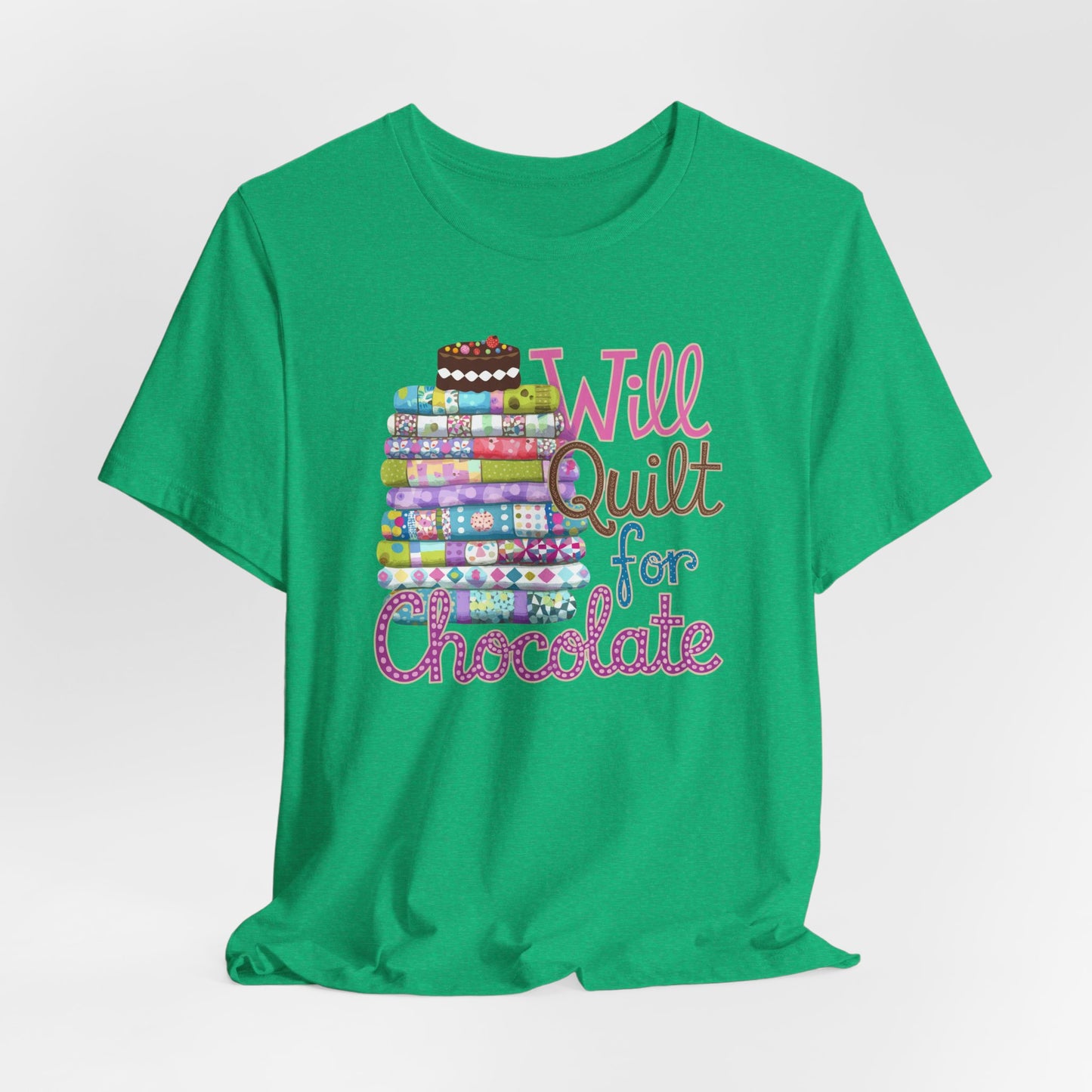 A Heather Kelly t-shirt featuring a whimsical design of a colorful stack of quilts topped with a chocolate cake and the phrase 'Will Quilt for Chocolate,' perfect for quilters who love sweets.