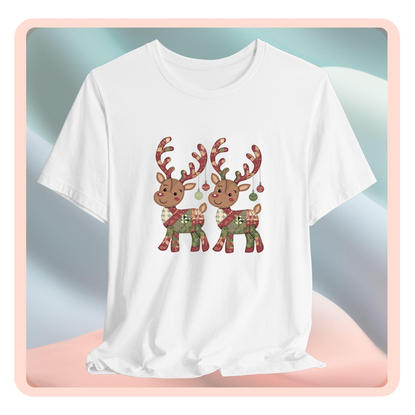 A christmas quilting t-shirt featuring two adorable reindeer featuring patchwork quilt designs on their bodies, with ornaments hanging from their antlers, blending Christmas cheer with quilting creativity.