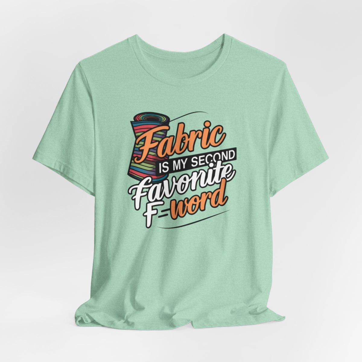 A Heather Mint T-Shirt with the phrase Fabric is My Second Favorite F-Word in a bold font next to a bolt of fabric