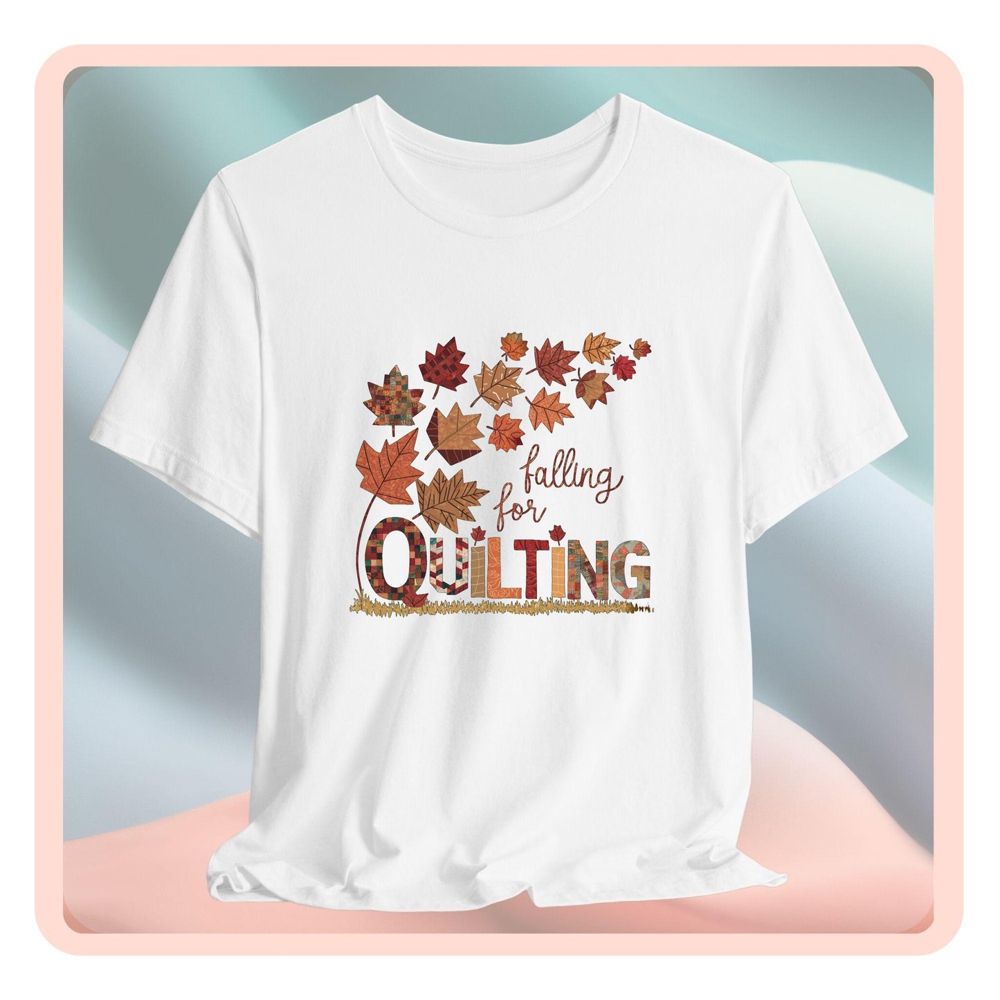 A thanksgiving quilting t-shirt featuring autumn leaves with various quilting patterns inside. Text reads "falling for QUILTING" with letters in patchwork style. Warm fall colors and quilting motifs combine in a seasonal design.