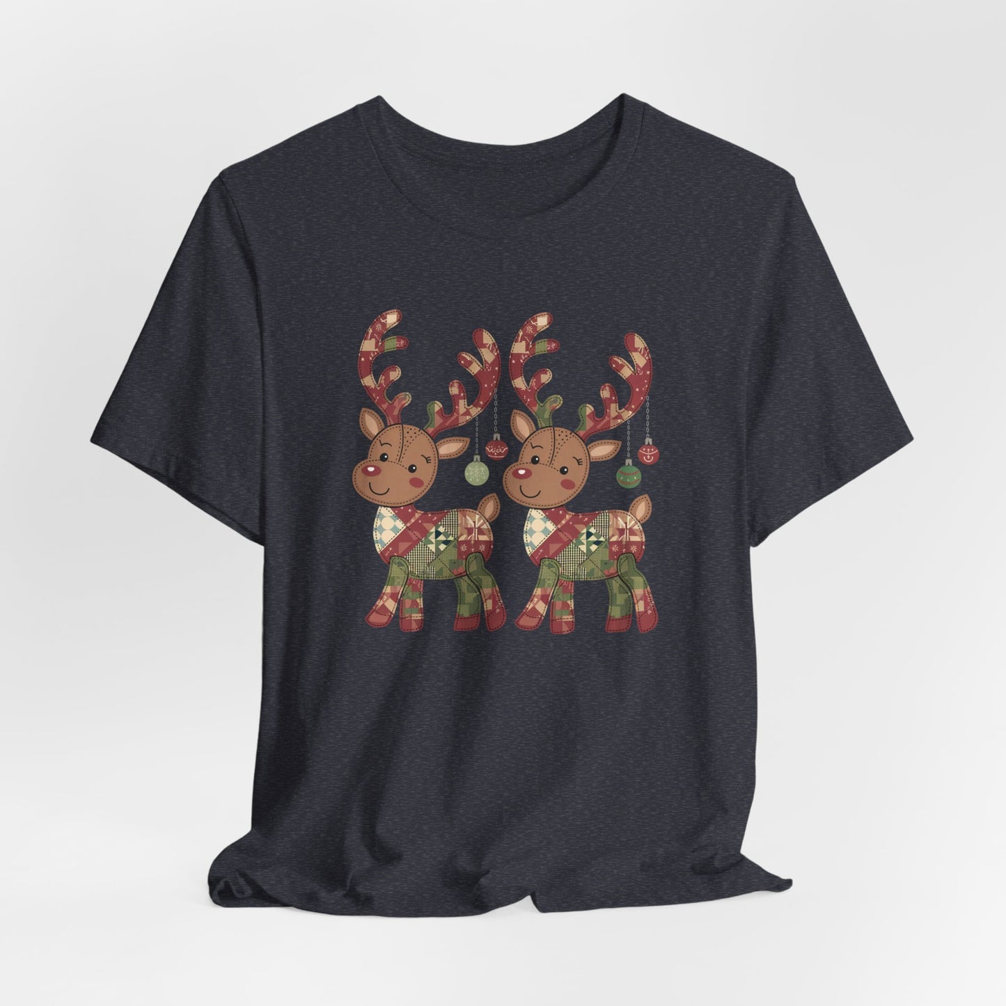 A Heather Navy christmas quilting t-shirt featuring two adorable reindeer featuring patchwork quilt designs on their bodies, with ornaments hanging from their antlers, blending Christmas cheer with quilting creativity.