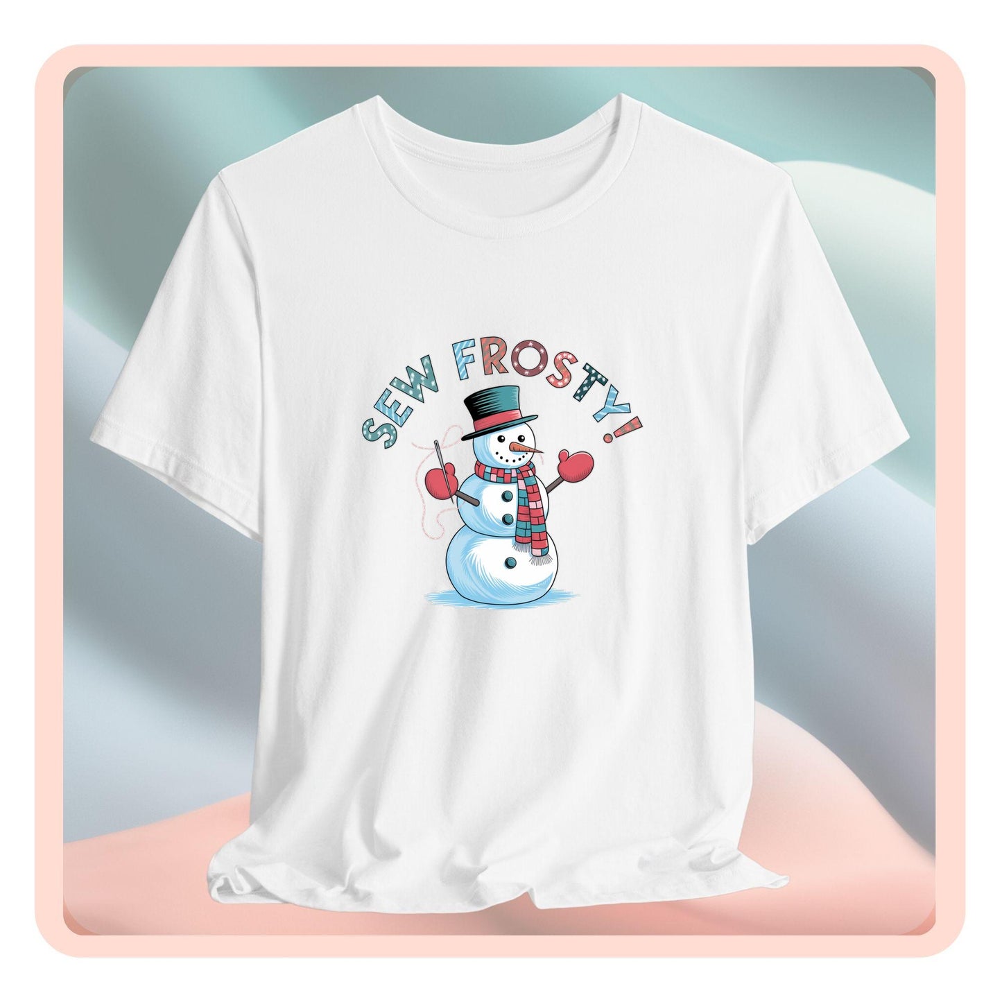 A christmas quilting t-shirt featuring cheerful snowman design holding a sewing needle, with the phrase "Sew Frosty" in playful, winter-themed lettering. The snowman is wearing a scarf and mittens, ready for holiday sewing fun.
