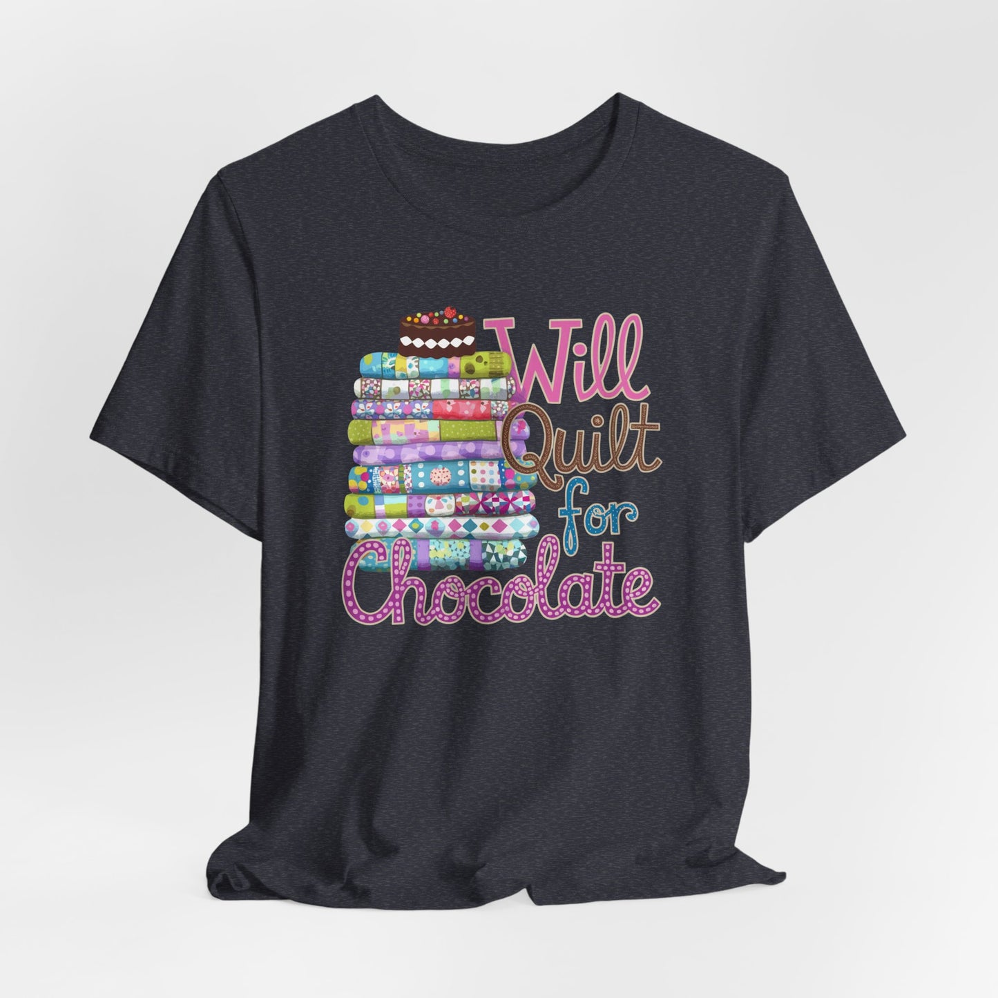 A Heather Navy t-shirt featuring a whimsical design of a colorful stack of quilts topped with a chocolate cake and the phrase 'Will Quilt for Chocolate,' perfect for quilters who love sweets.