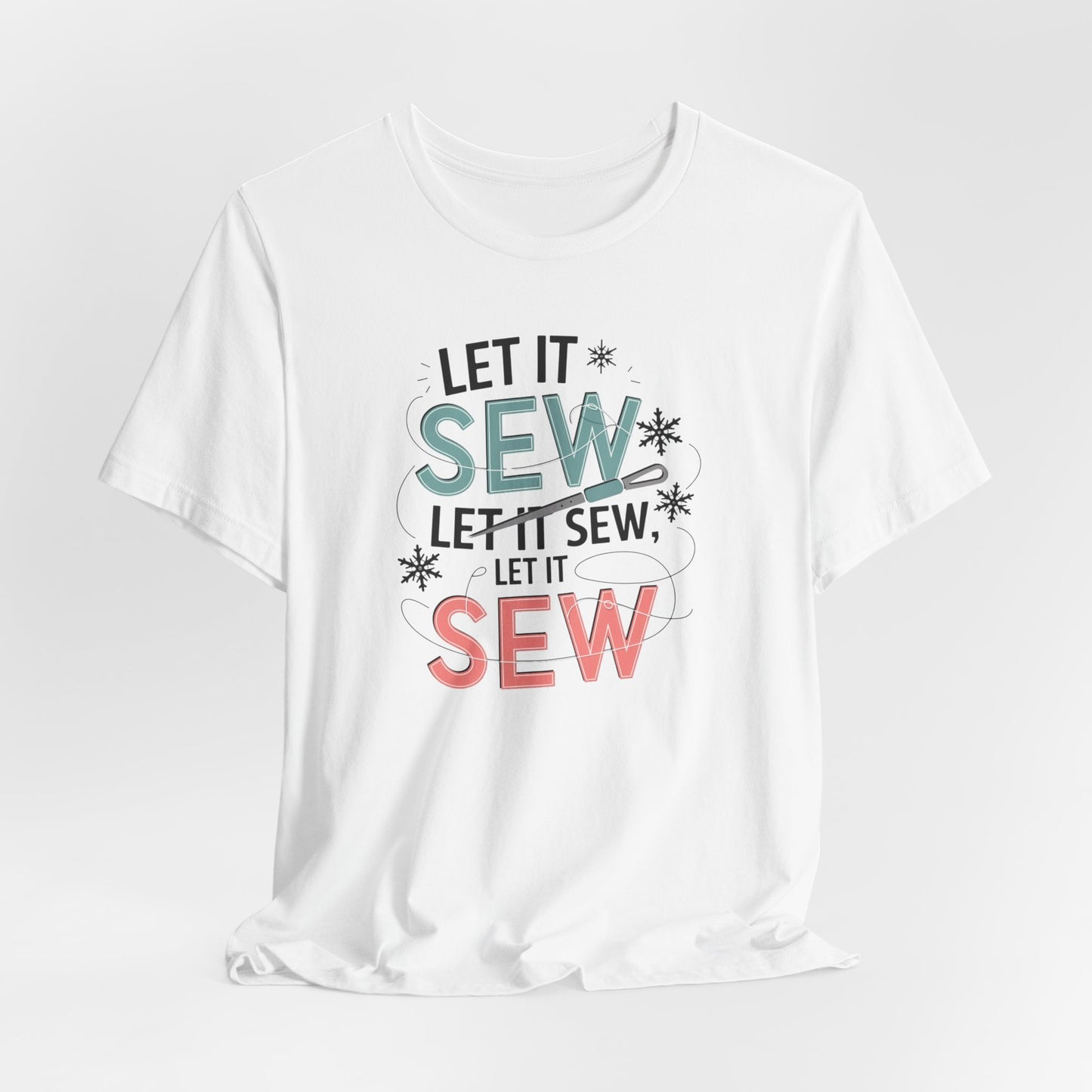 A White christmas quilting t-shirt featuring the phrase "Let it Sew, Let it Sew, Let it Sew" featuring a needle and thread weaving through the letters, accented by snowflakes to bring out the holiday theme.