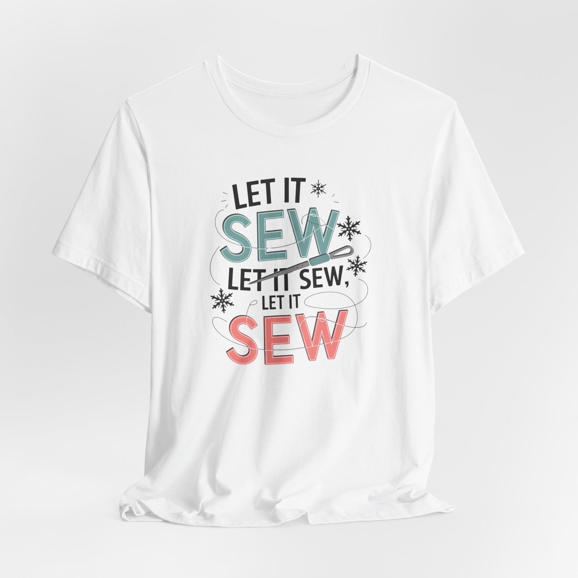 A White christmas quilting t-shirt featuring the phrase "Let it Sew, Let it Sew, Let it Sew" featuring a needle and thread weaving through the letters, accented by snowflakes to bring out the holiday theme.