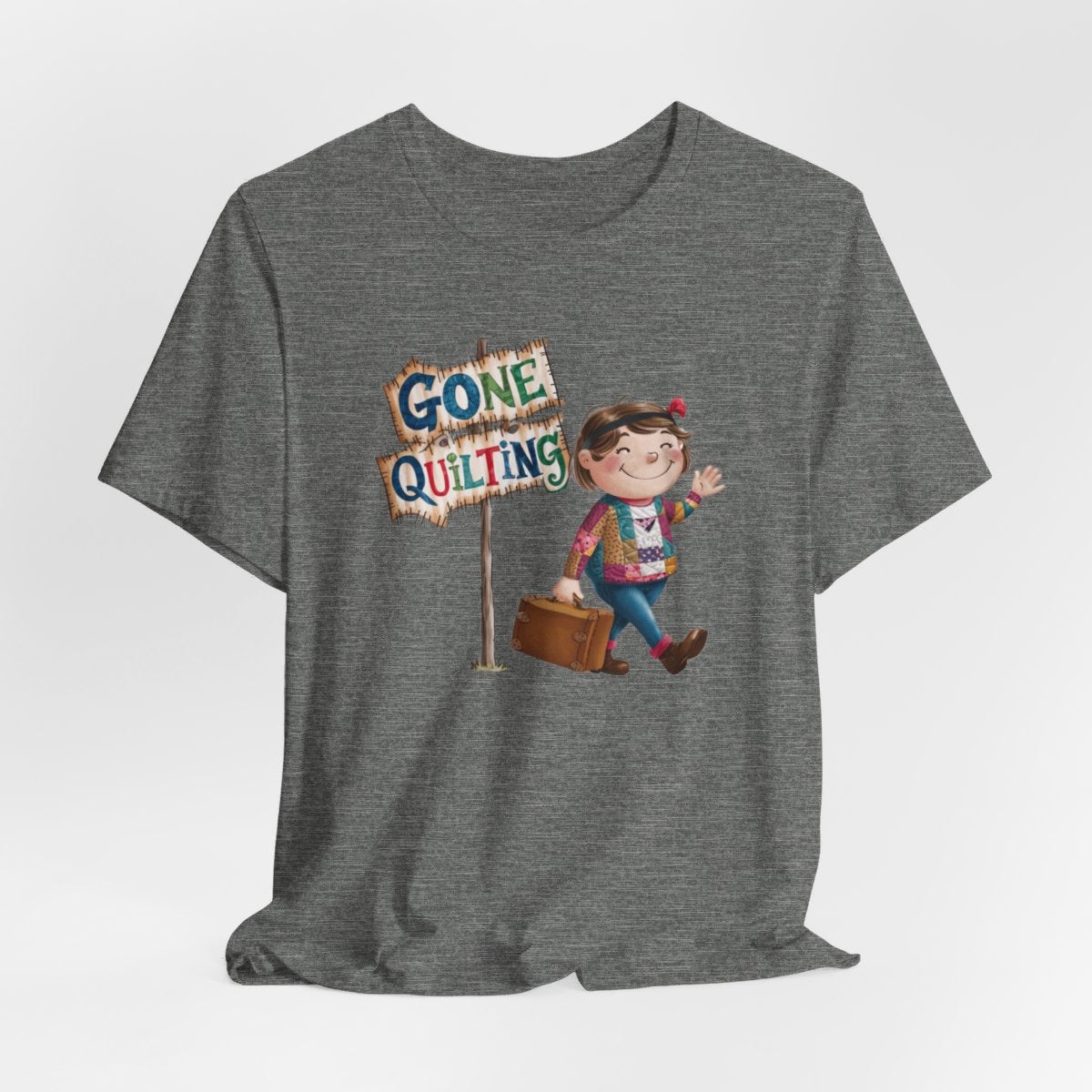 A Deep Heatherfun quilting T-Shirt with a cartoon illustration of a smiling girl wearing a patchwork jacket, carrying a suitcase next to a wooden sign that reads "Gone Quilting" in colorful letters.