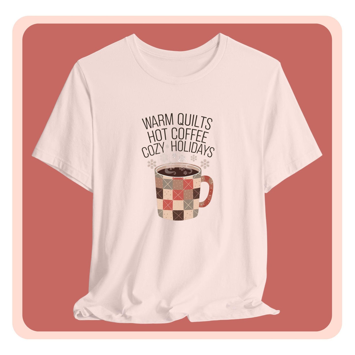 A christmas quilting t-shirt featuring a cozy patchwork quilt-themed coffee mug, surrounded by snowflakes, with the phrase "Warm Quilts, Hot Coffee, Cozy Holidays" above the mug, celebrating the warmth of quilts and coffee during the holiday season.