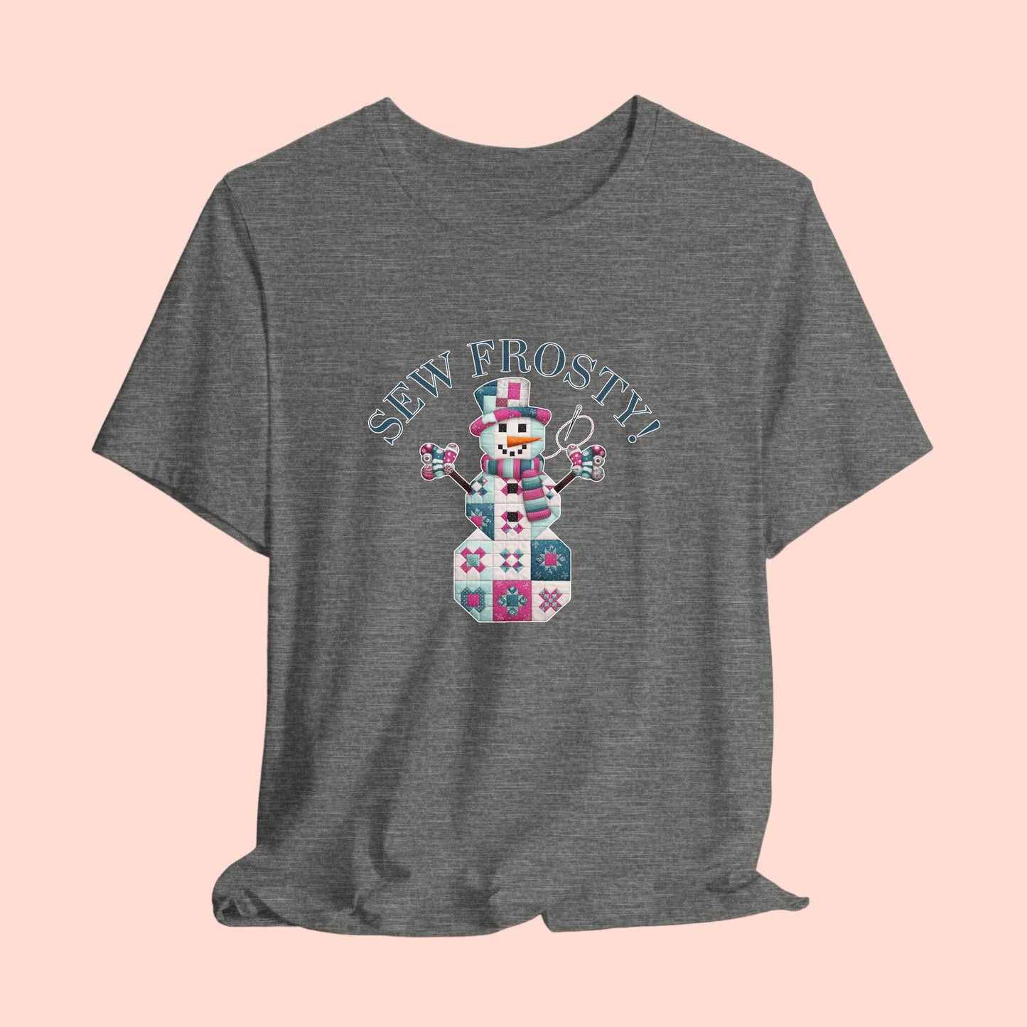 A christmas quilting t-shirt featuring cute snowman made of patchwork quilt blocks with the phrase "Sew Frosty" above, holding a needle to highlight the quilting theme.