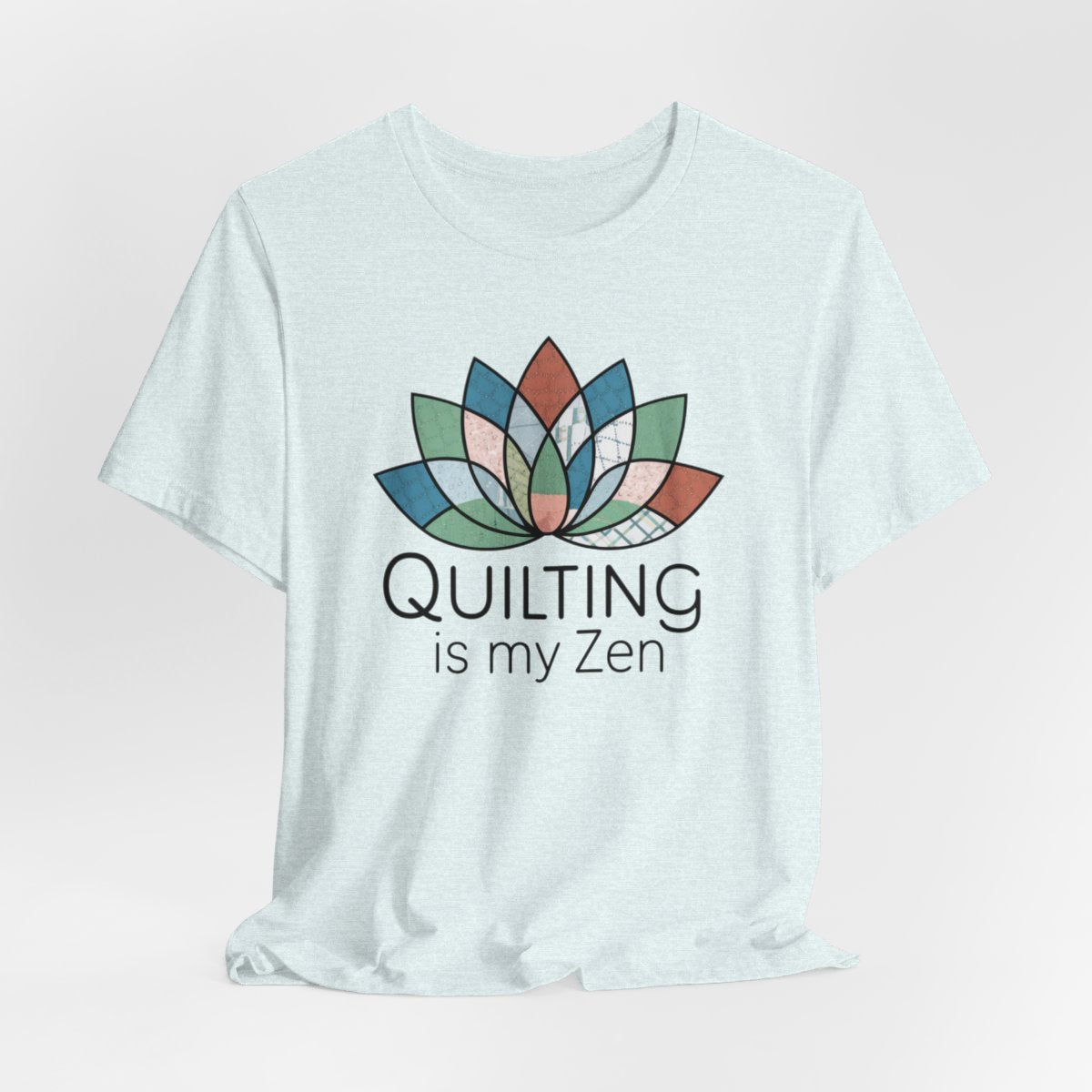 A Heather Ice Blue funny quilting T-Shirt with the phrase Quilting is my Zen on a quilting-themed t-shirt with a lotus flower design made of various quilt patterns and textures.