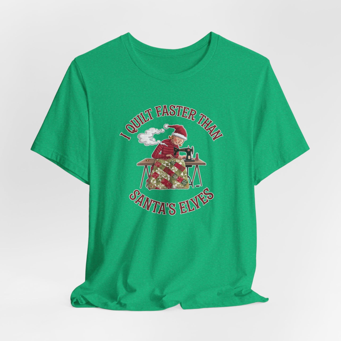 A Heather Kelly christmas quilting t-shirt featuring a quilter working at a sewing machine, quilting a festive holiday quilt, with the phrase "I Quilt Faster Than Santa's Elves" above the image, highlighting the speed and skill of the quilter.