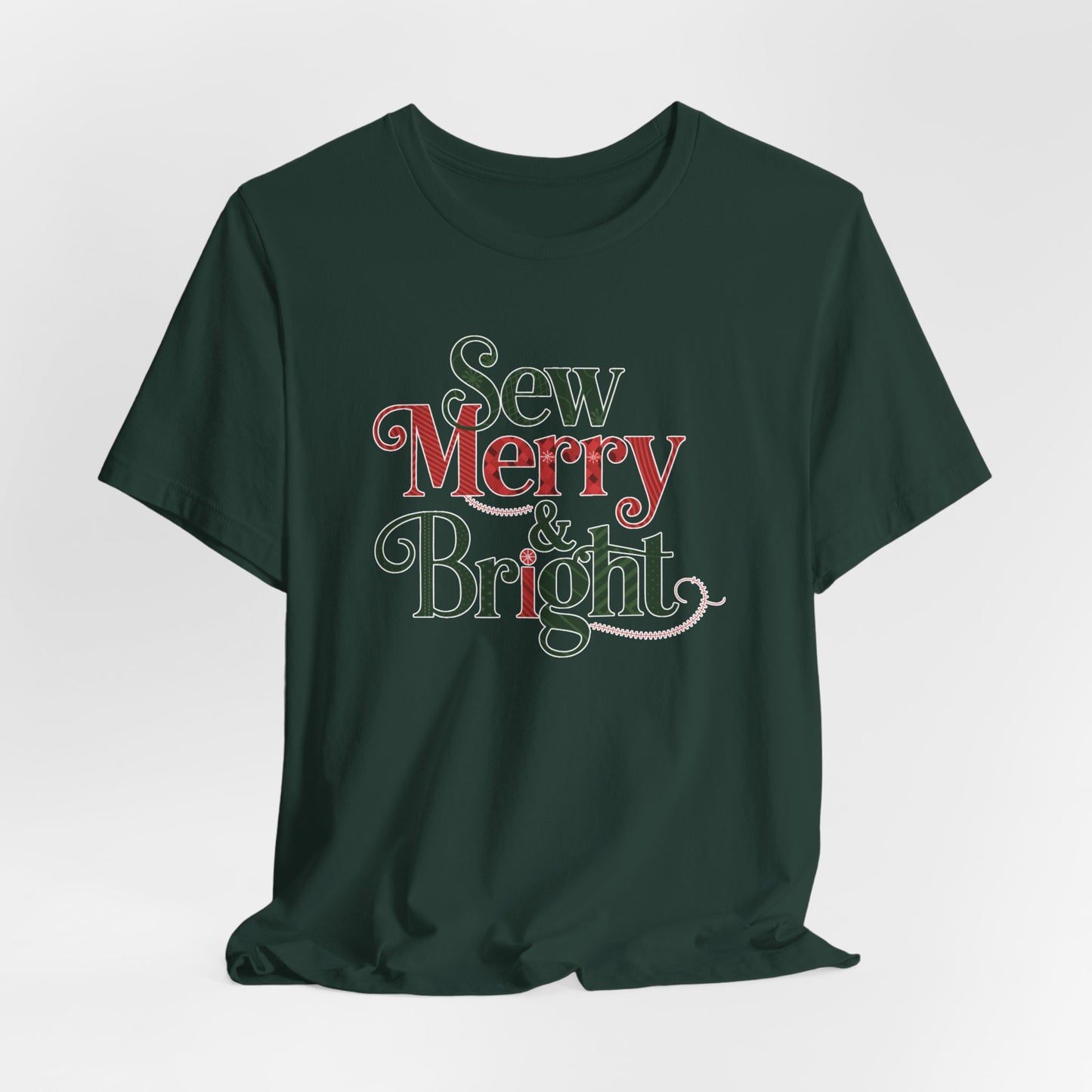 A Forest t-shirt with the phrase "Sew Merry & Bright," incorporating sewing-inspired elements and holiday-themed accents, such as stitching lines and festive patterns.