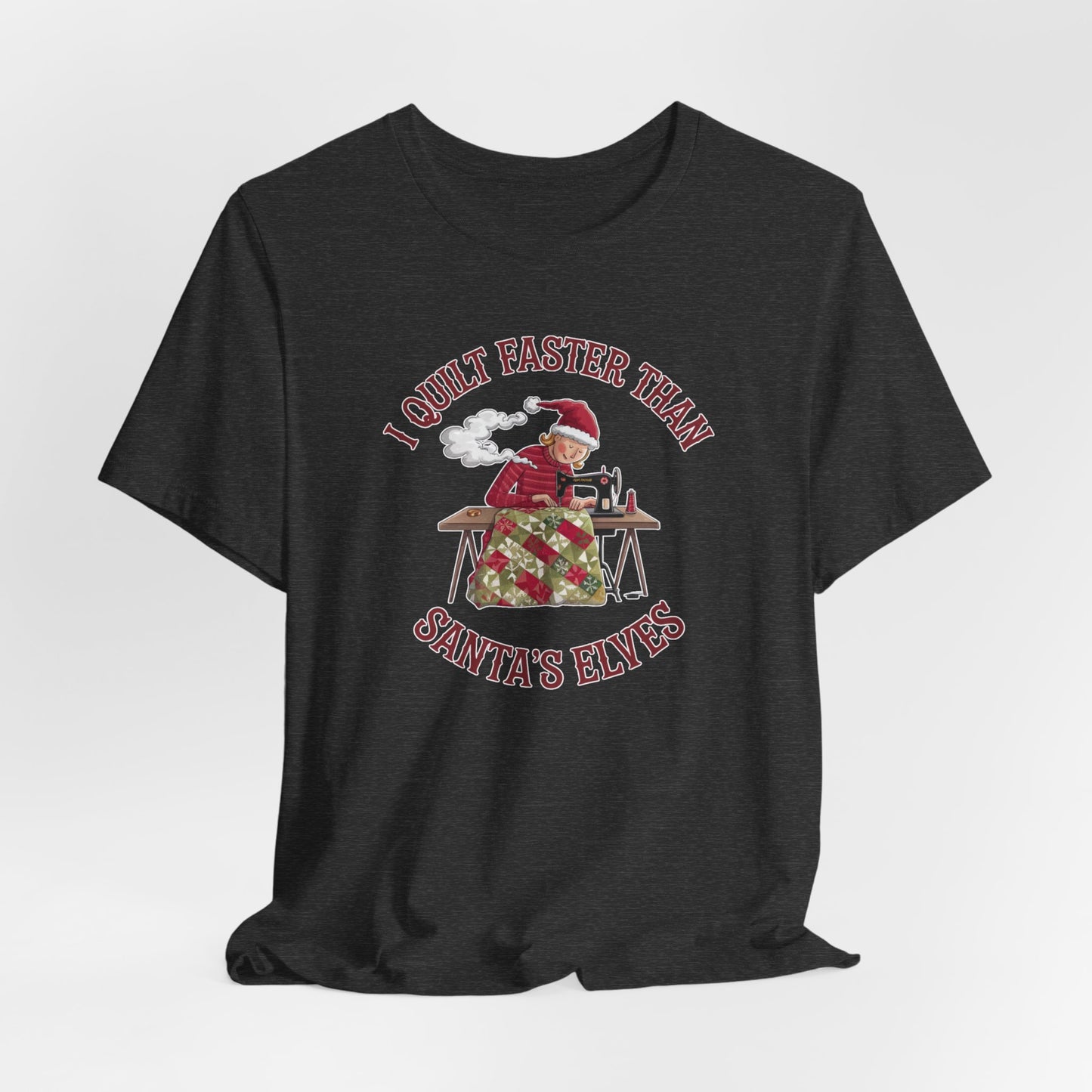 A Dark Grey Heather christmas quilting t-shirt featuring a quilter working at a sewing machine, quilting a festive holiday quilt, with the phrase "I Quilt Faster Than Santa's Elves" above the image, highlighting the speed and skill of the quilter.
