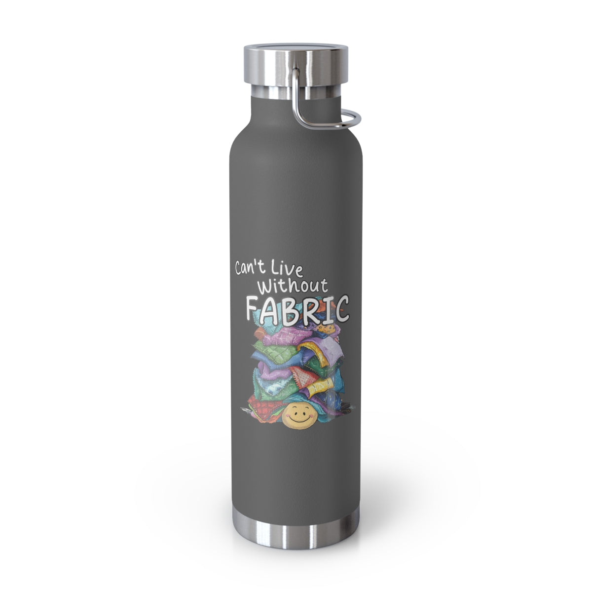 A Grey funny quilting-inspired Insulated Bottle with a cute illustration showing a happy face under a pile of multicolored fabric pieces. Hand-lettered text says "Can't Live Without Fabric". The fabrics display various patterns and textures.