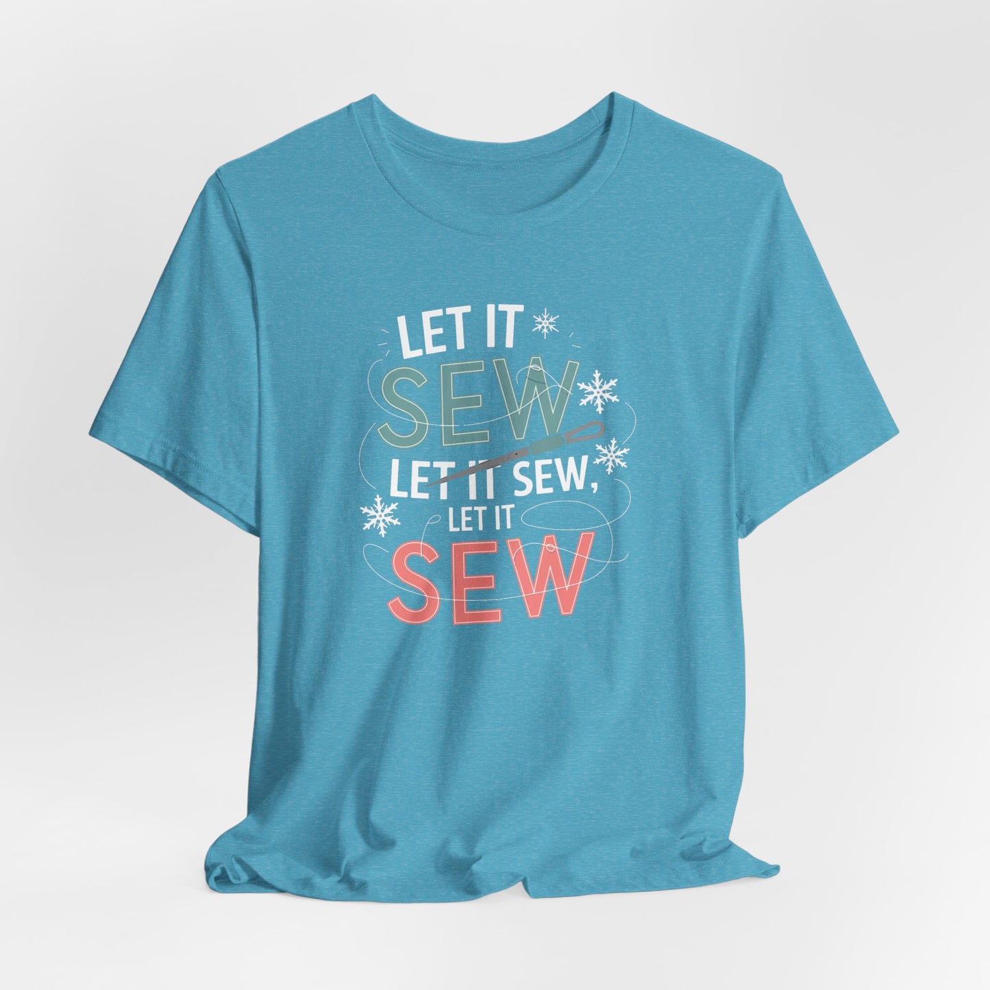 A Heather Aqua christmas quilting t-shirt featuring the phrase "Let it Sew, Let it Sew, Let it Sew" featuring a needle and thread weaving through the letters, accented by snowflakes to bring out the holiday theme.