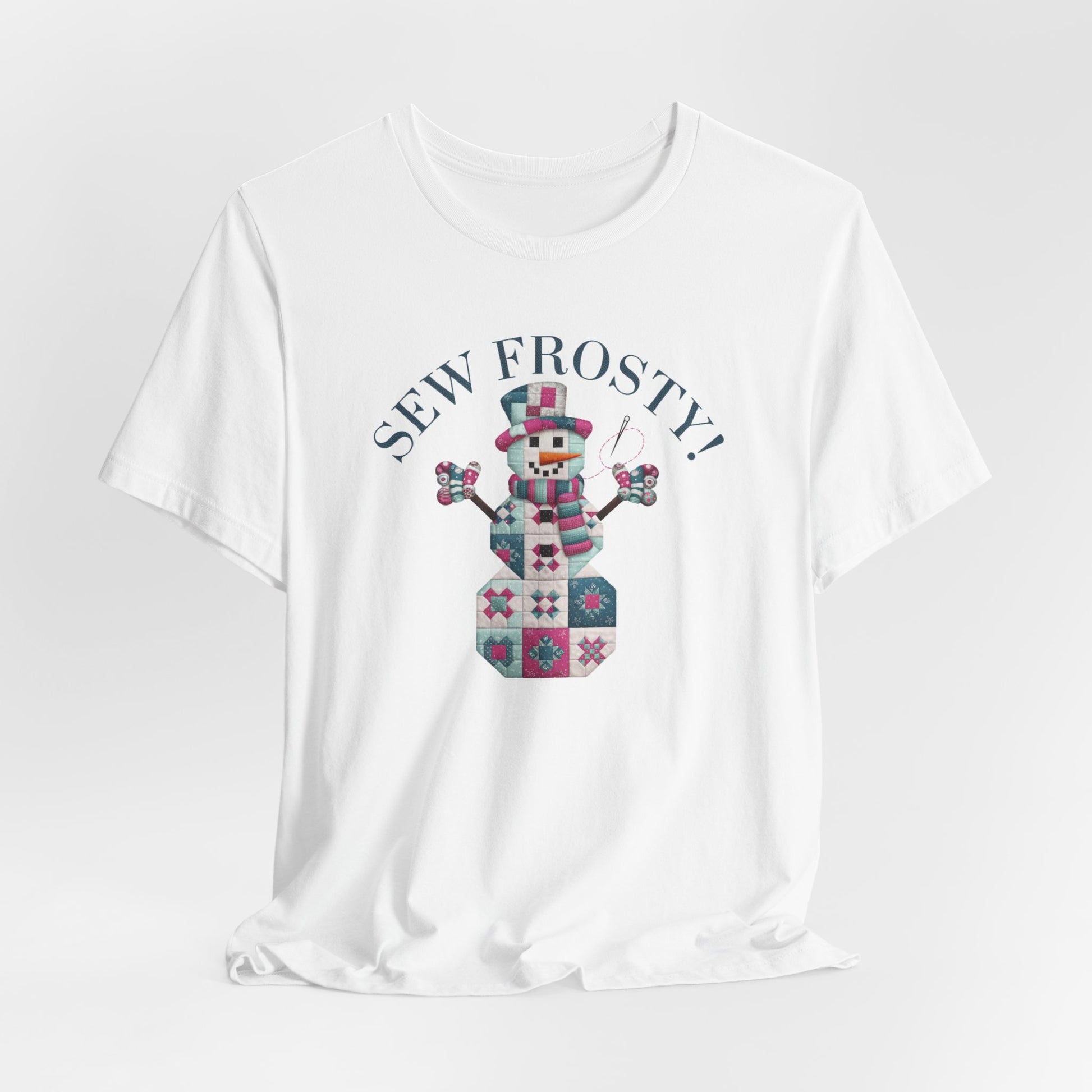 A White christmas quilting t-shirt featuring cute snowman made of patchwork quilt blocks with the phrase "Sew Frosty" above, holding a needle to highlight the quilting theme.