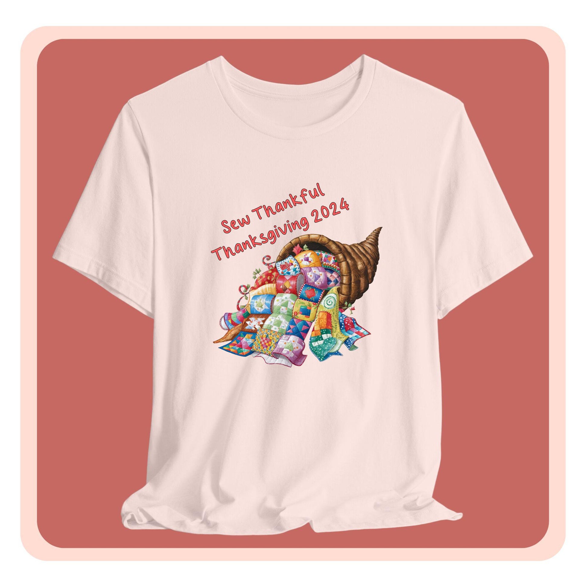A thanksgiving  quilting t-shirt featuring a colorful quilted cornucopia overflowing with various quilt patterns and designs. Text reads "Sew Thankful Thanksgiving 2024" in red. Vibrant illustration combines quilting motifs with Thanksgiving imagery.