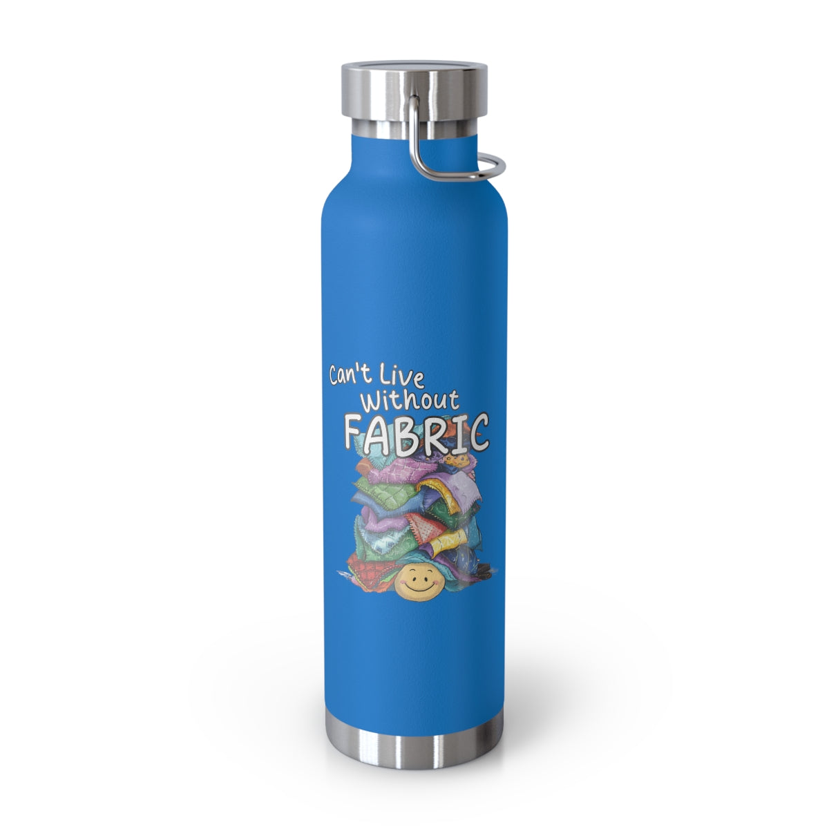 A Pebble Blue funny quilting-inspired Insulated Bottle with a cute illustration showing a happy face under a pile of multicolored fabric pieces. Hand-lettered text says "Can't Live Without Fabric". The fabrics display various patterns and textures.