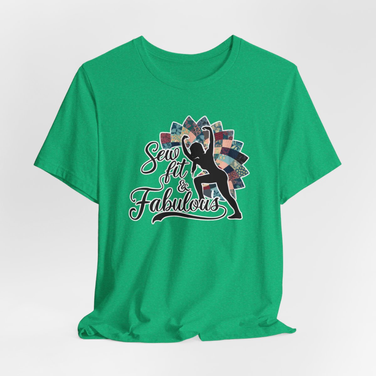 A Heather Kelly T-Shirt featuring a black silhouette of woman with raised arms against colorful patchwork background. Text reads "Sew fit & Fabulous" in stylized script.