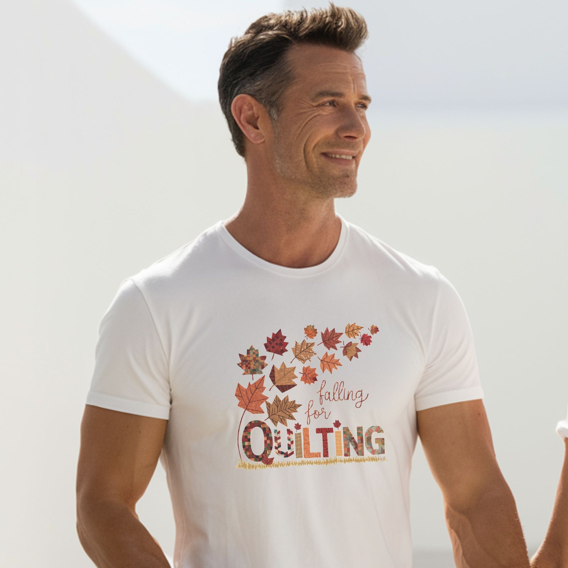 A thanksgiving  quilting t-shirt featuring autumn leaves with various quilting patterns inside. Text reads "falling for QUILTING" with letters in patchwork style. Warm fall colors and quilting motifs combine in a seasonal design.