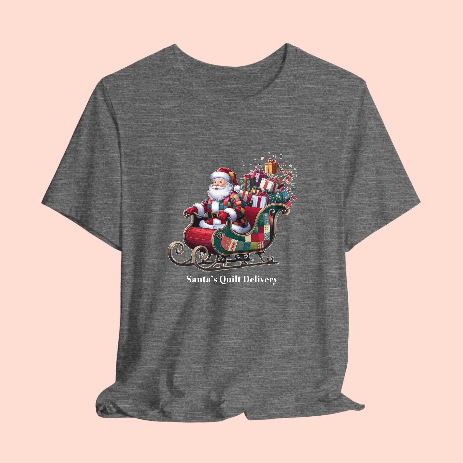 A christmas quilting t-shirt featuring Santa Claus wearing a patchwork quilt coat, sitting in a sleigh filled with gifts and quilts, with the phrase "Santa's Quilt Delivery" below, combining holiday cheer and quilting fun.
