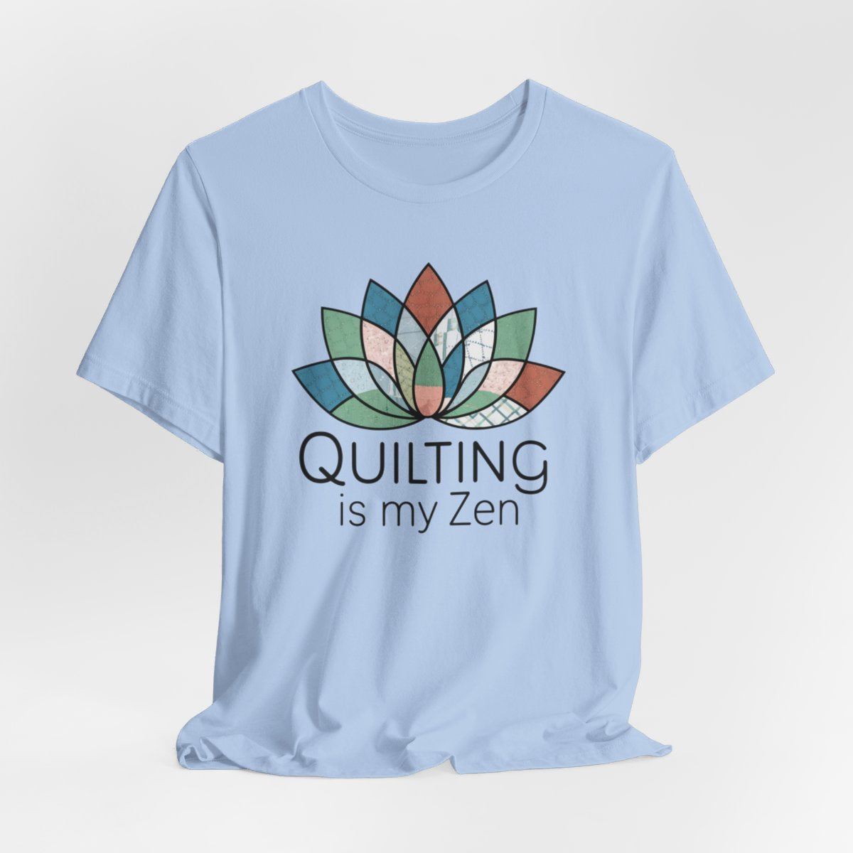 A Baby Blue funny quilting T-Shirt with the phrase Quilting is my Zen on a quilting-themed t-shirt with a lotus flower design made of various quilt patterns and textures.