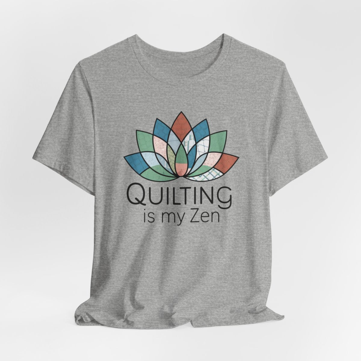 An Athletic Heather funny quilting T-Shirt with the phrase Quilting is my Zen on a quilting-themed t-shirt with a lotus flower design made of various quilt patterns and textures.