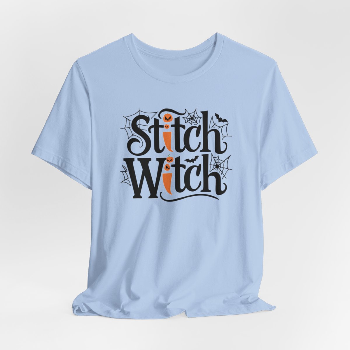 T-shirt design with "Stitch Witch" text in Halloween-themed typography. Jack-o'-lanterns, spiderwebs, and bats decorate the letters. The "i" in "Stitch" resembles a sewing needle. Ideal for quilters who love Halloween.