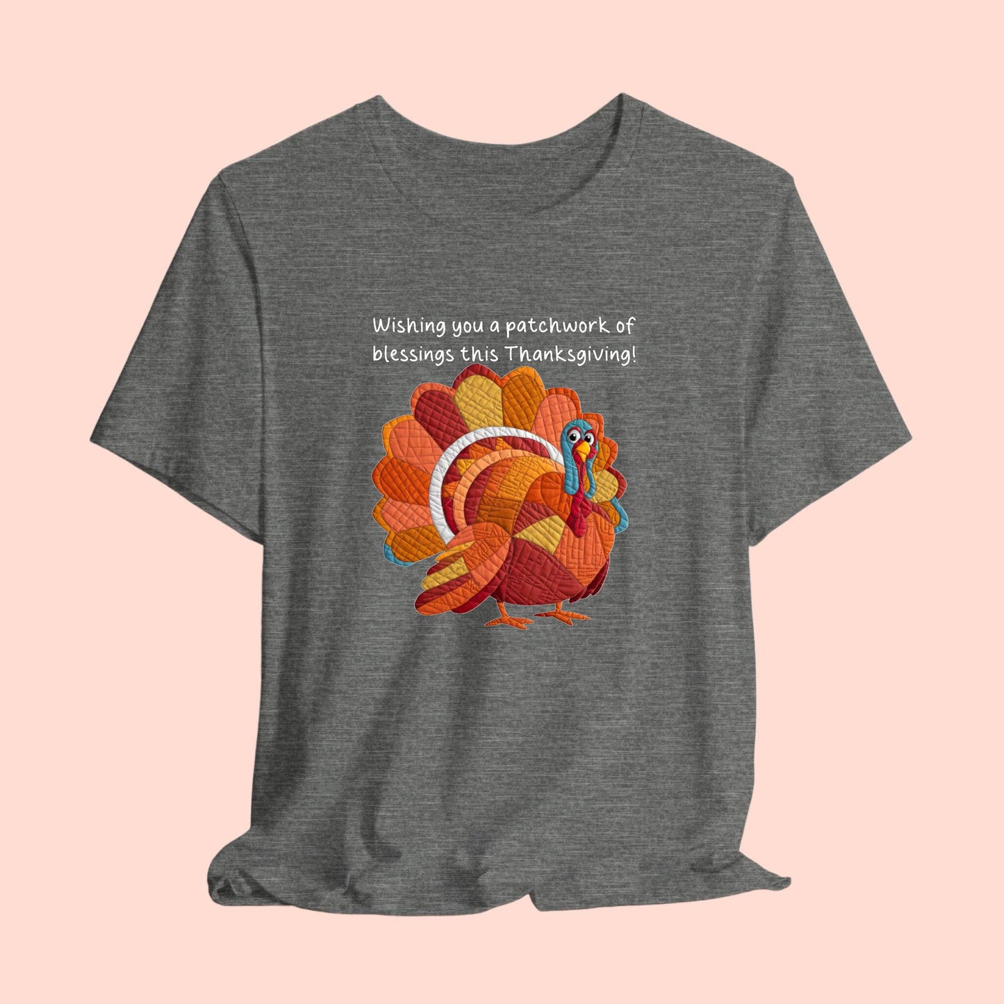 A thanksgiving quilting t-shirt featuring a quilted patchwork turkey in autumn colors with text "Wishing you a patchwork of blessings this Thanksgiving!" Turkey features various quilt patterns and textures in shades of orange, red, yellow, and blue. Whimsical, crafty holiday design perfect for quilting enthusiasts.
