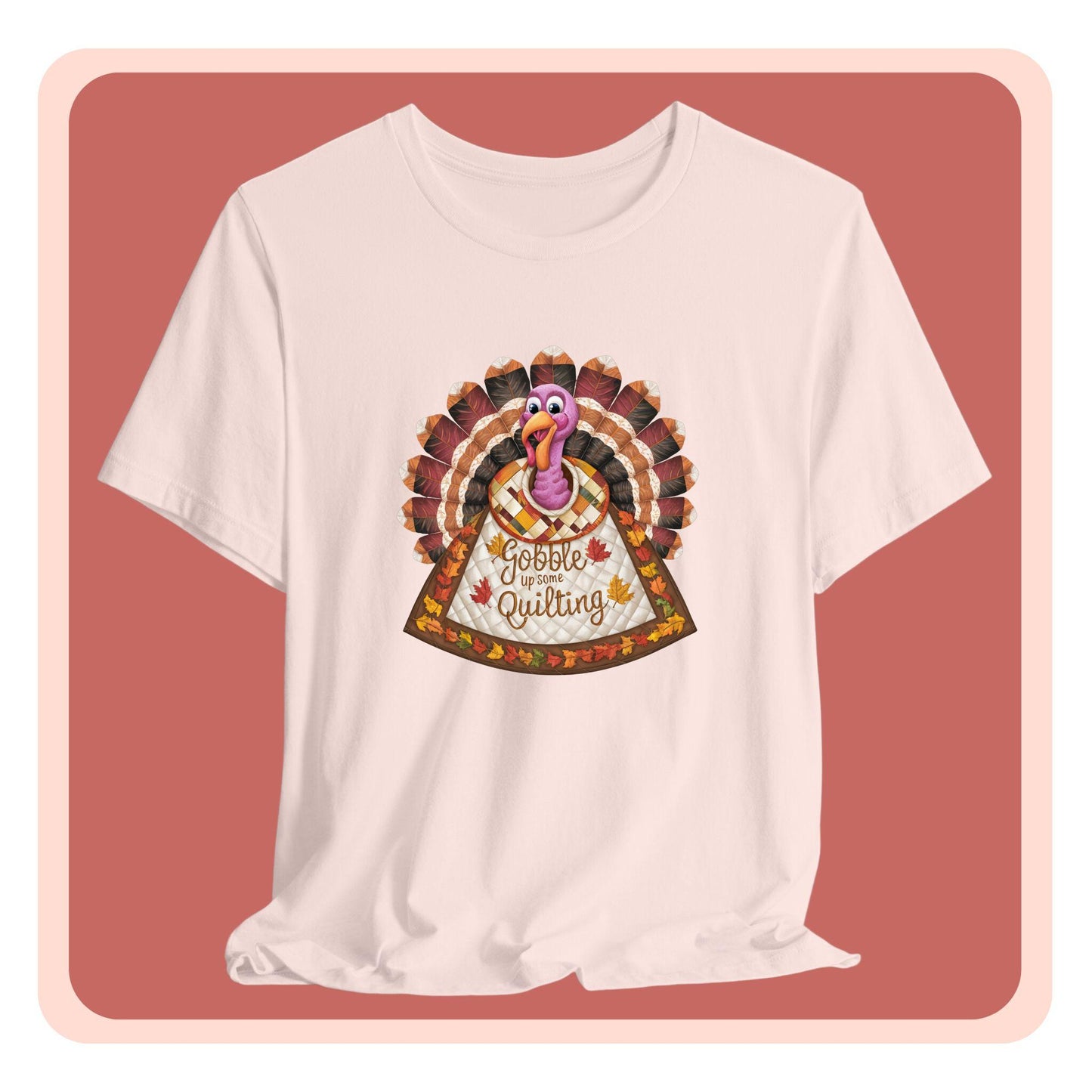 A thanksgiving quilting t-shirt featuring a quilted turkey design with colorful patchwork feathers and body. Text on turkey reads "Gobble up some Quilting" surrounded by fall leaves. Combines Thanksgiving imagery with quilting motifs in a whimsical illustration.